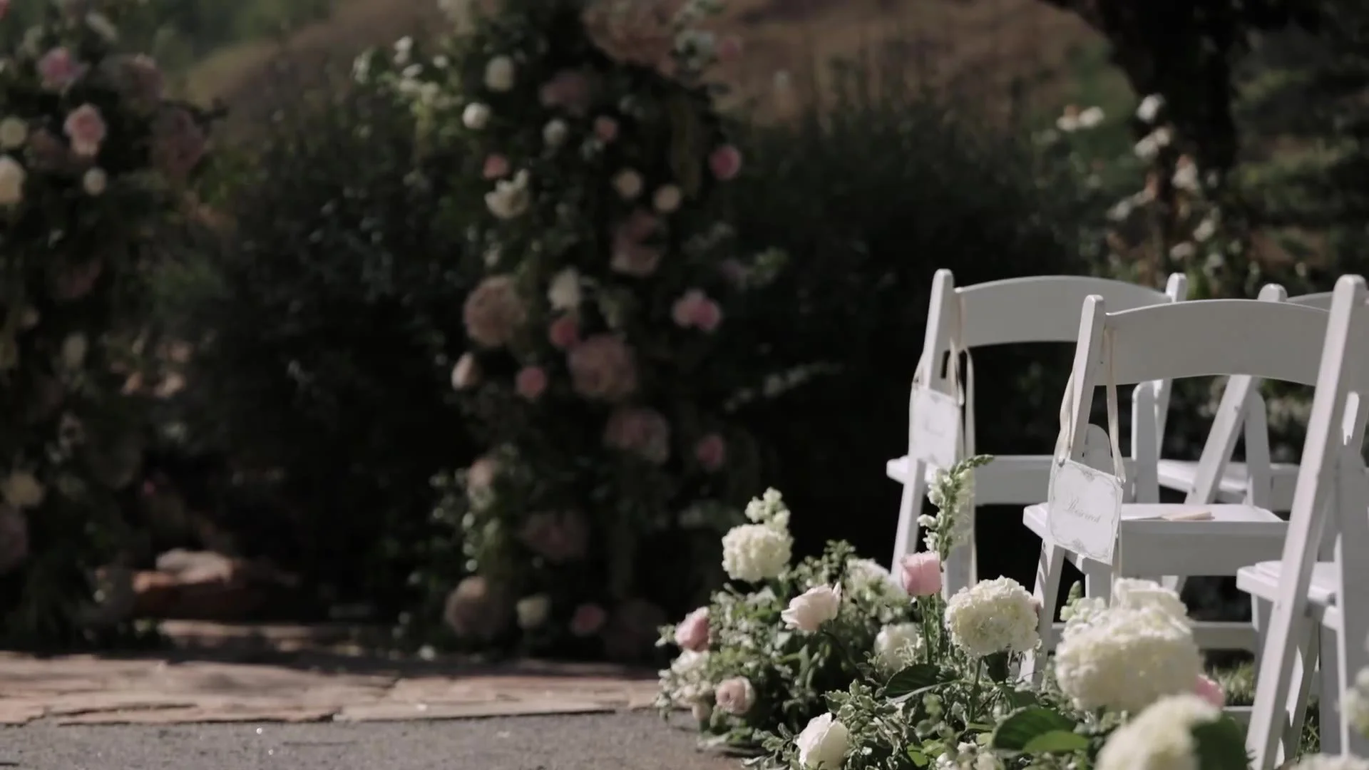White chairs, reserved sign, and hydrangea aisle florals at Crested Butte Wedding Garden in Colorado