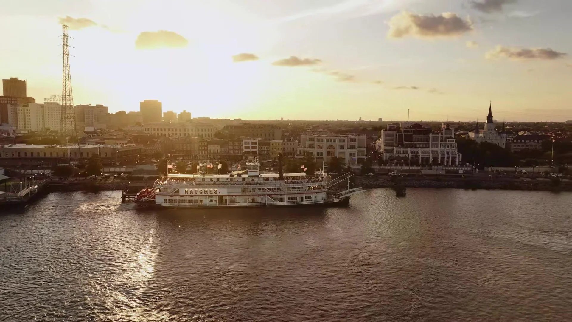Steamboat Natchez on the Mississippi River at sunset with the French Quarter skyline and St. Louis Cathedral