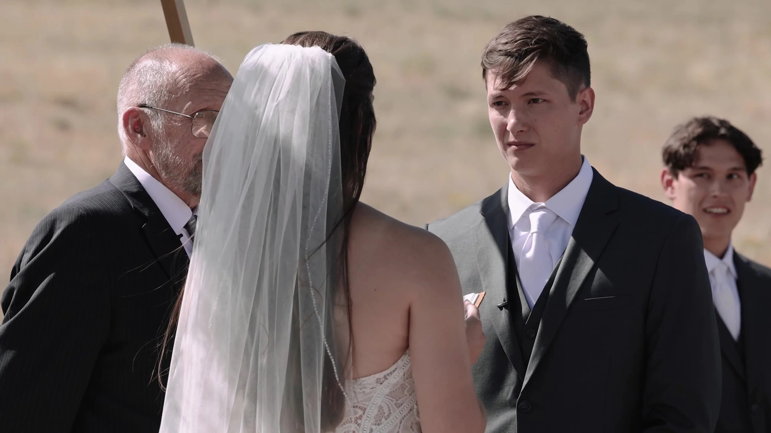 Groom looking at the bride during vows at 3 Peaks Ranch in Westcliffe, Colorado