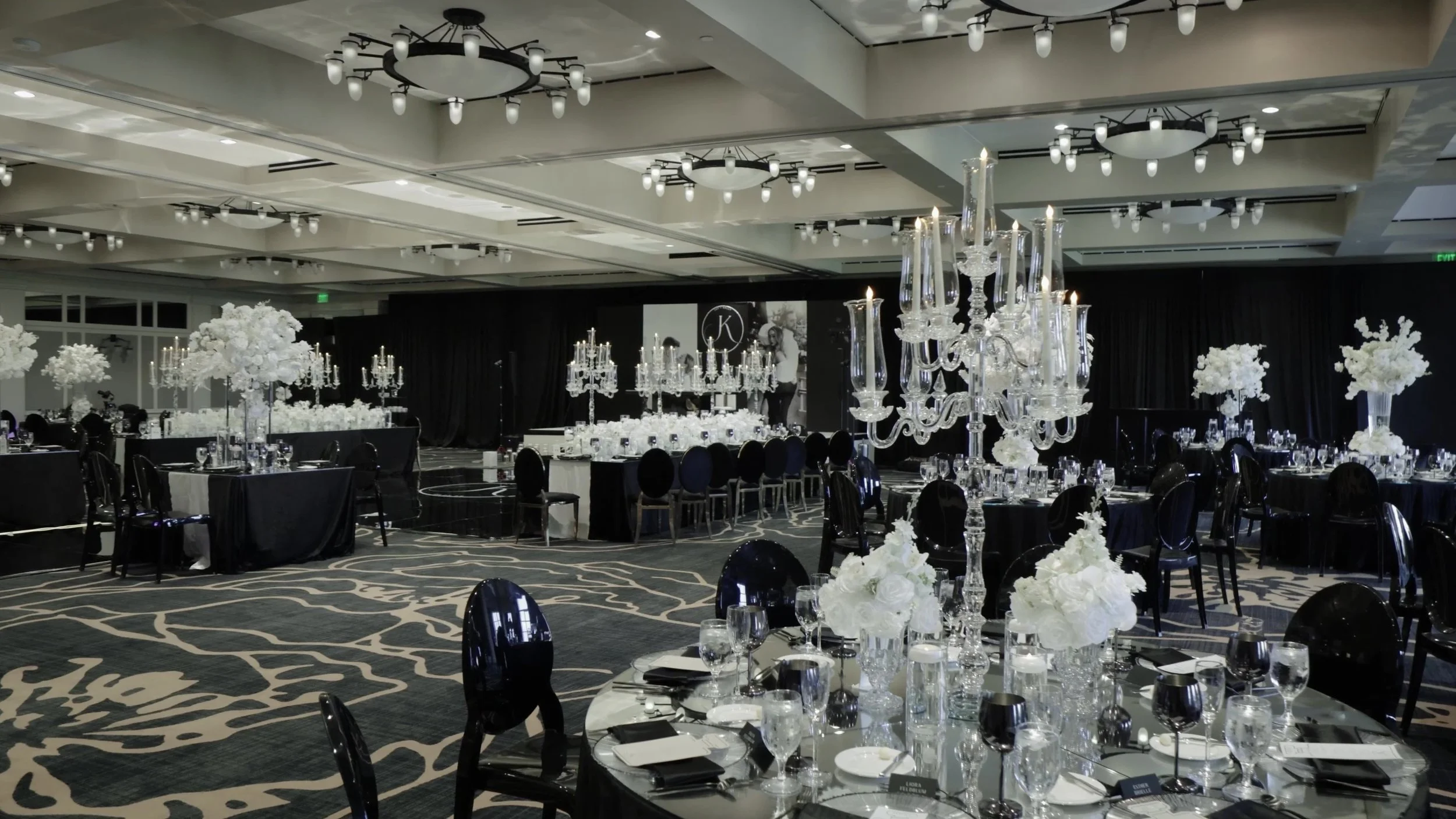 Empty black and white reception ballroom with crystal candelabras at Barton Creek Country Club Austin