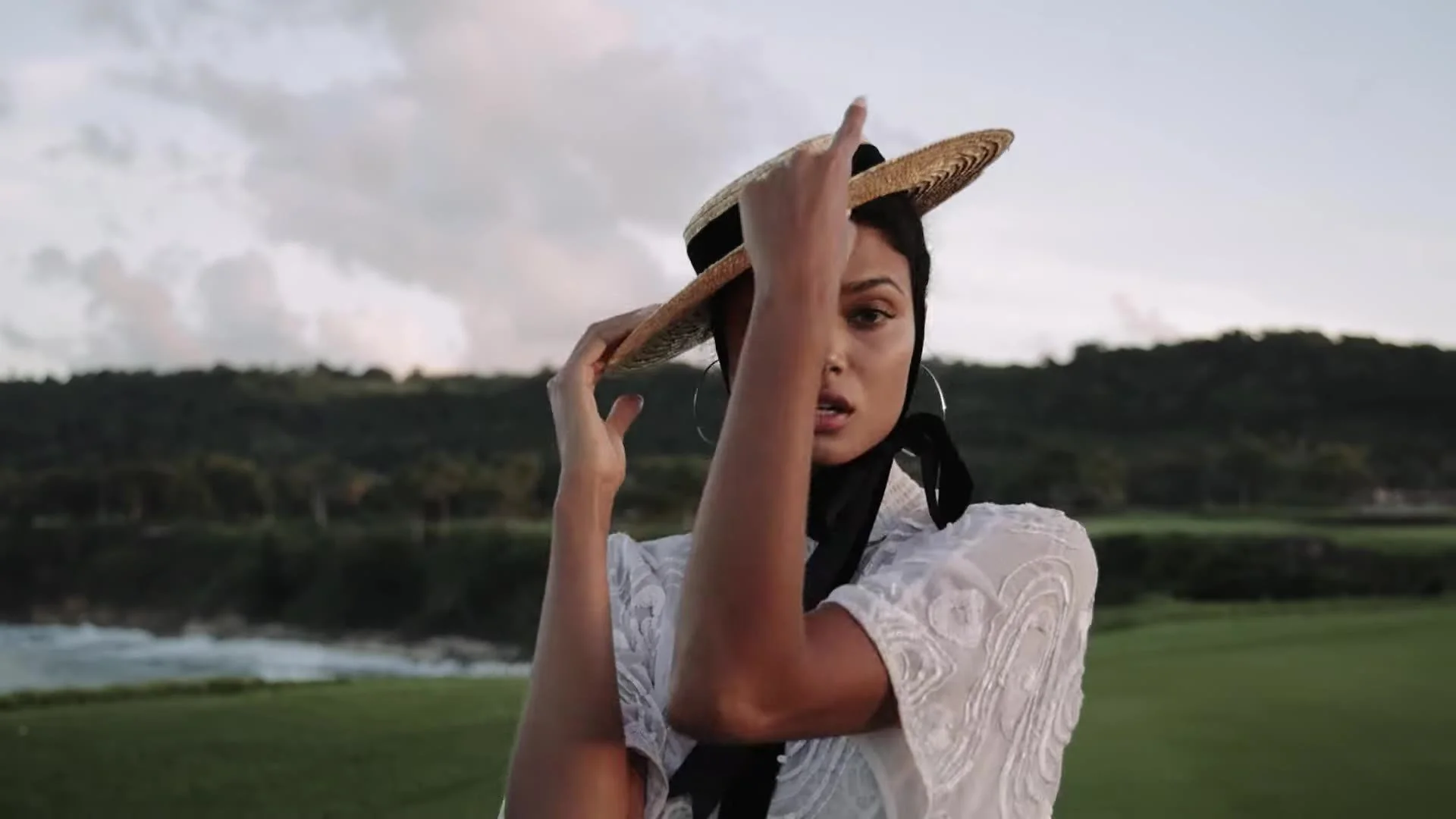 Daniela in a wide straw hat with tropical hills at Amanera Dominican Republic