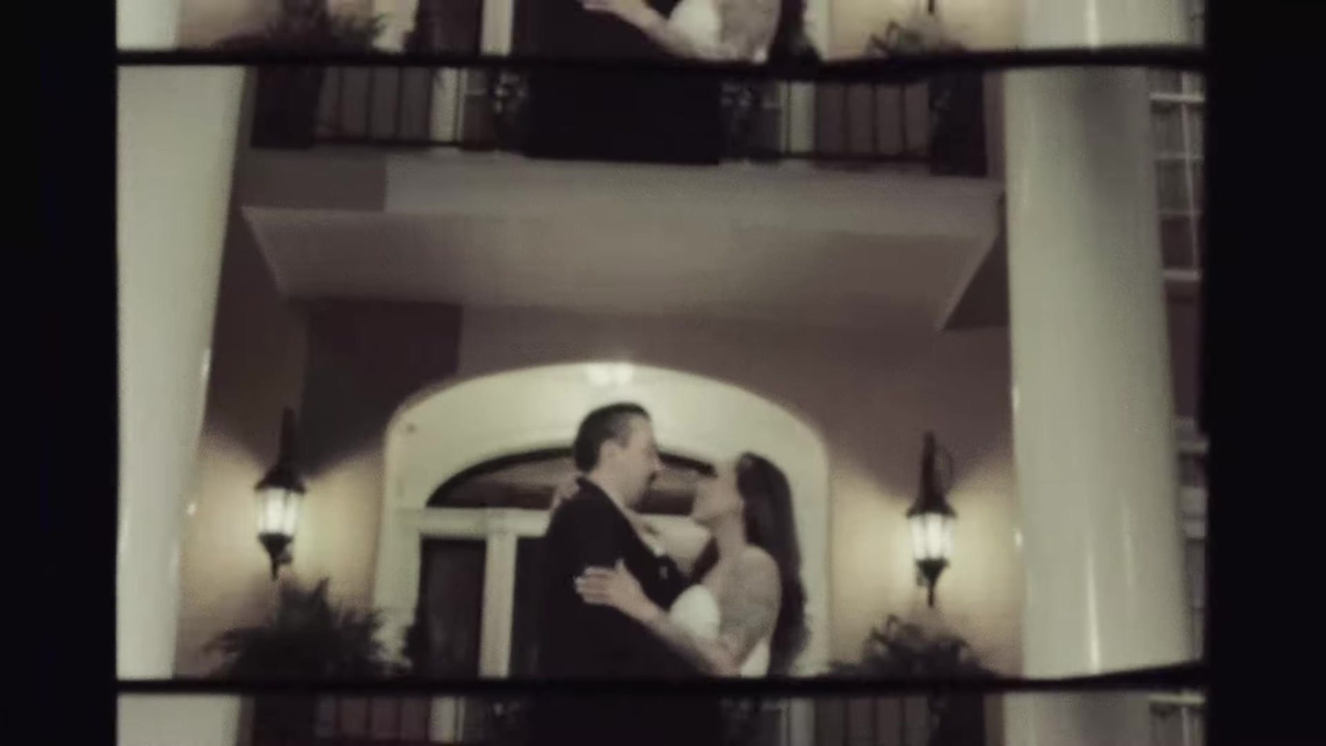 Blair and Gustavo embracing between white columns at Southern Oaks Plantation in New Orleans, vintage film frame
