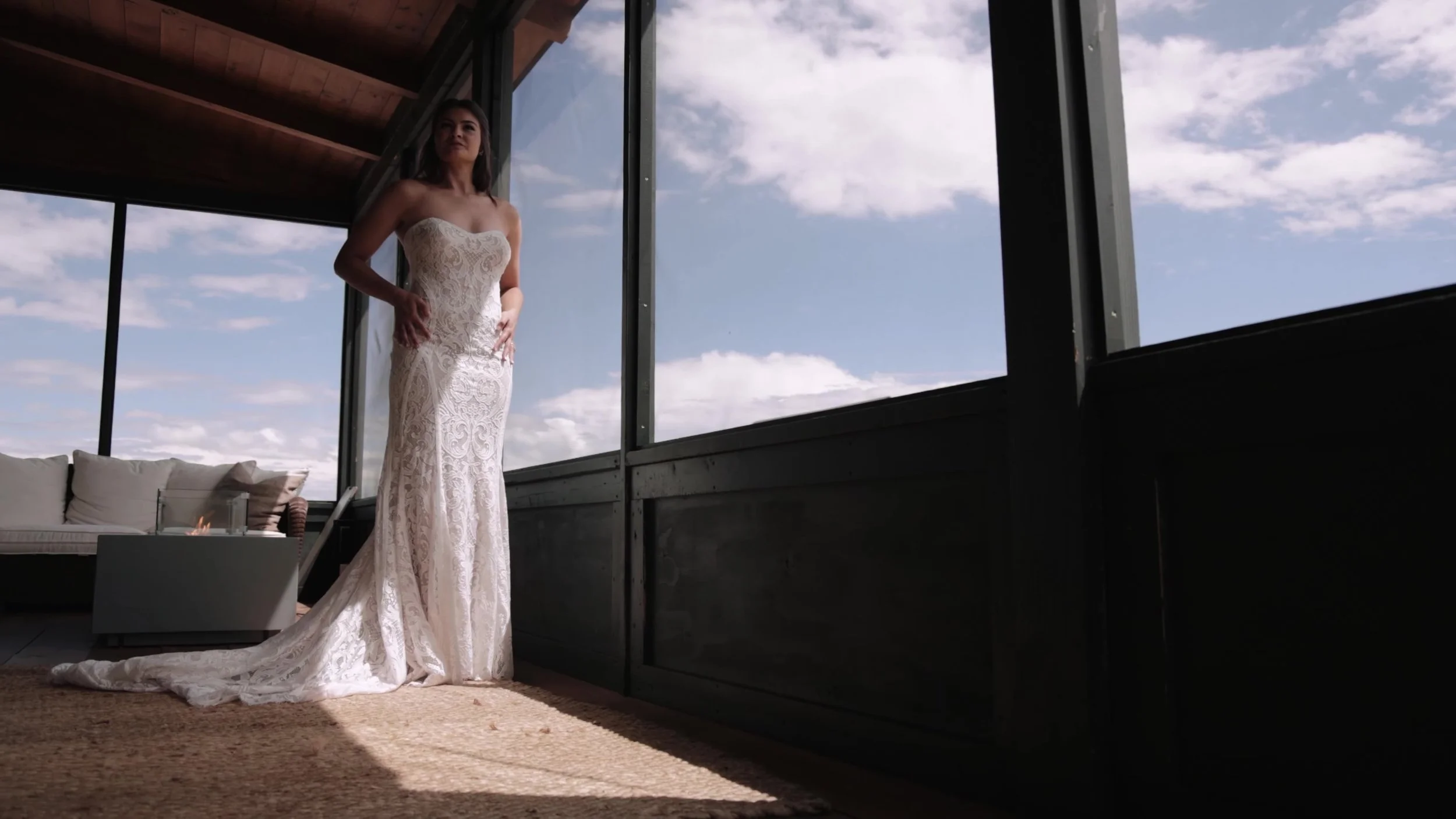 Bride in a lace gown in a windowed ranch room at 3 Peaks Ranch in Westcliffe, Colorado