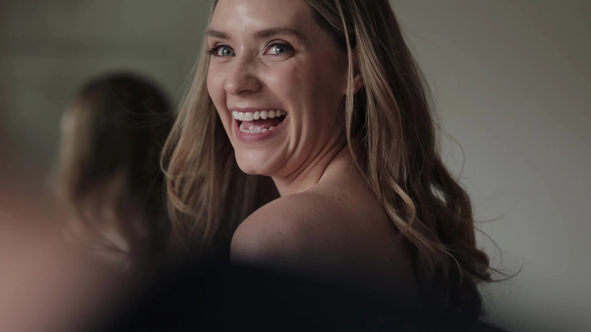 Bride laughing over her shoulder at Northstar Gatherings in Idaho Springs, Colorado