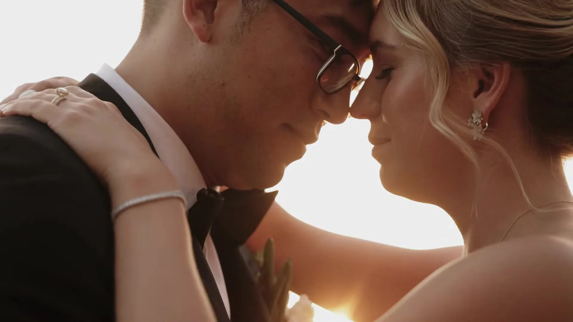 Tight portrait of Jason and Rachel with foreheads touching at Canyonwood Ridge in Dripping Springs, Texas, rings on her hand