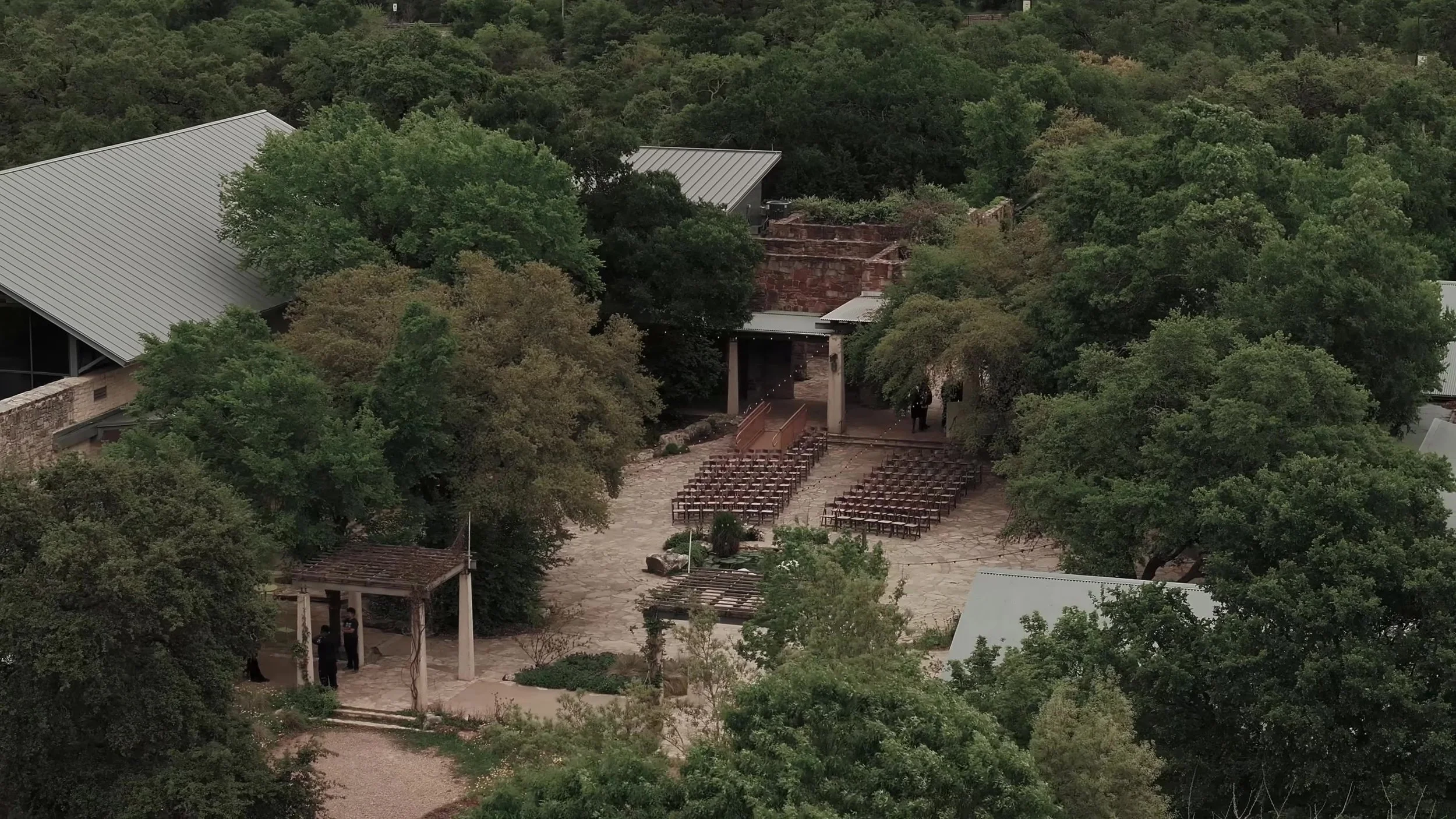 Aerial view of the outdoor ceremony courtyard and stone buildings at Lady Bird Johnson Wildflower Center in Austin, Texas