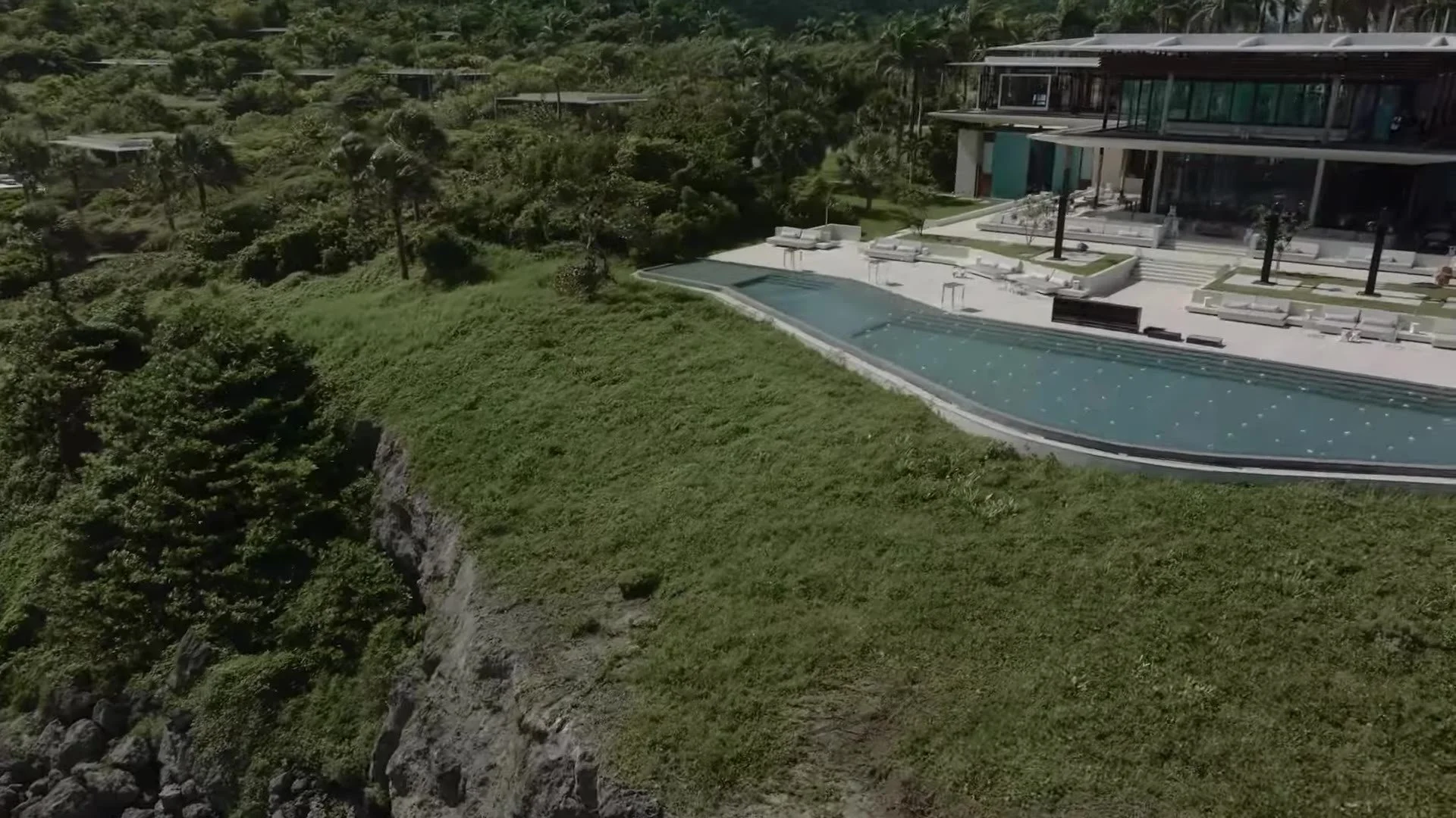 Aerial of Amanera infinity pool and modern roofs in the Dominican Republic jungle