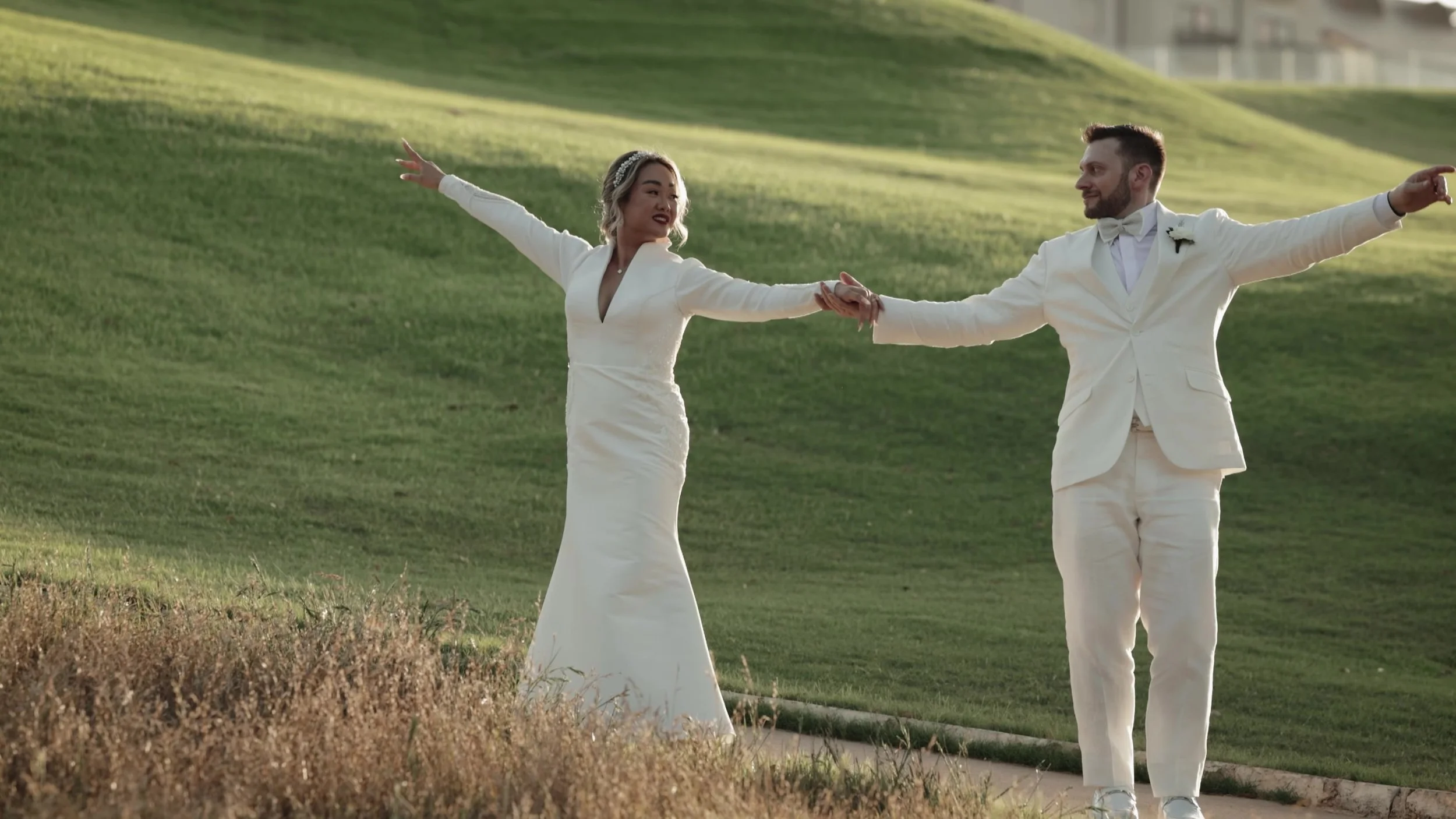 Wide golden hour walk of Keely and Jay on the greens at Barton Creek Country Club Austin