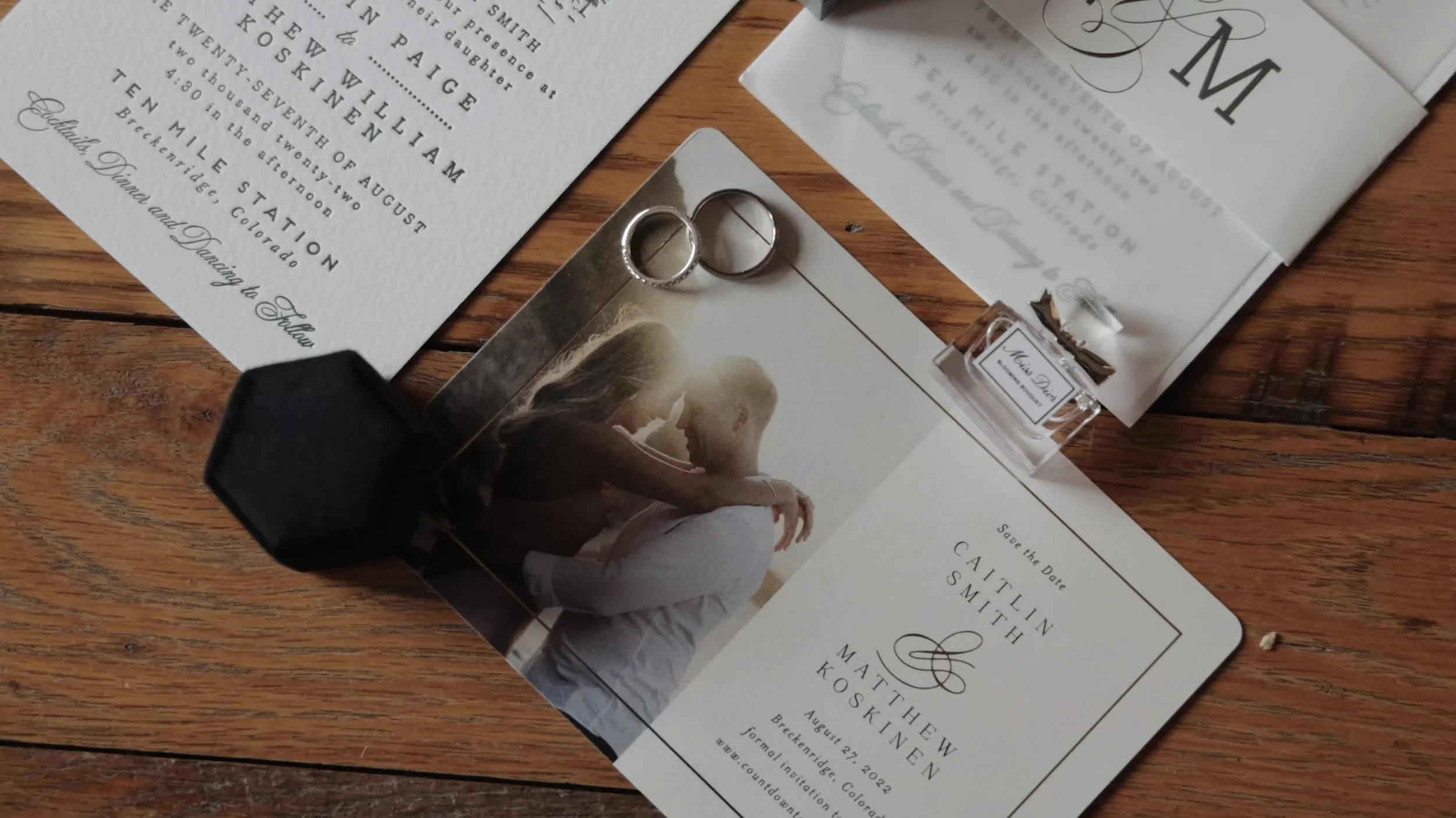 Caitlin and Matthew wedding invitations and rings for Ten Mile Station in Breckenridge, Colorado