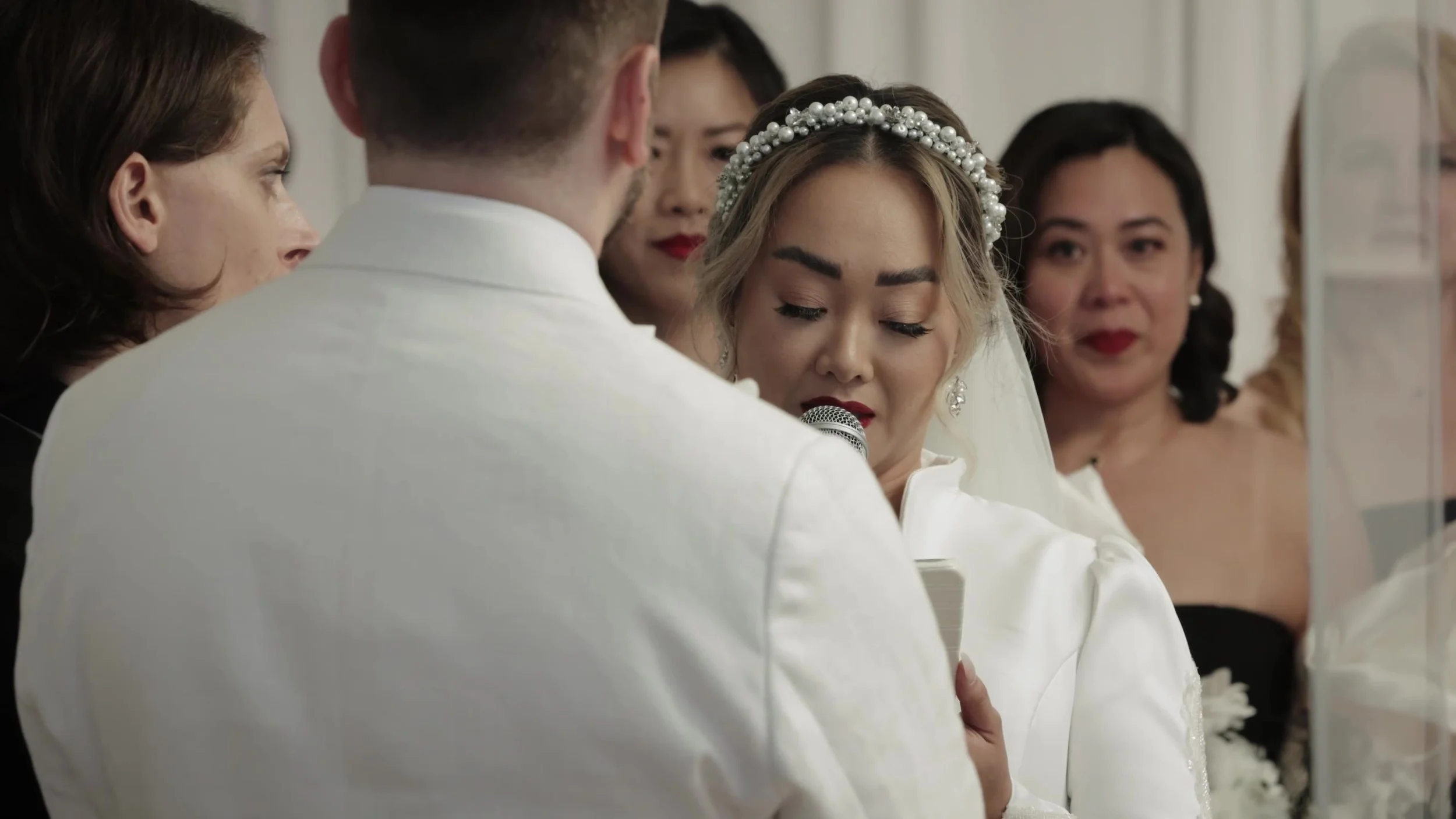 Tight frame of Keely speaking vows with Jay in foreground at Barton Creek Country Club Austin