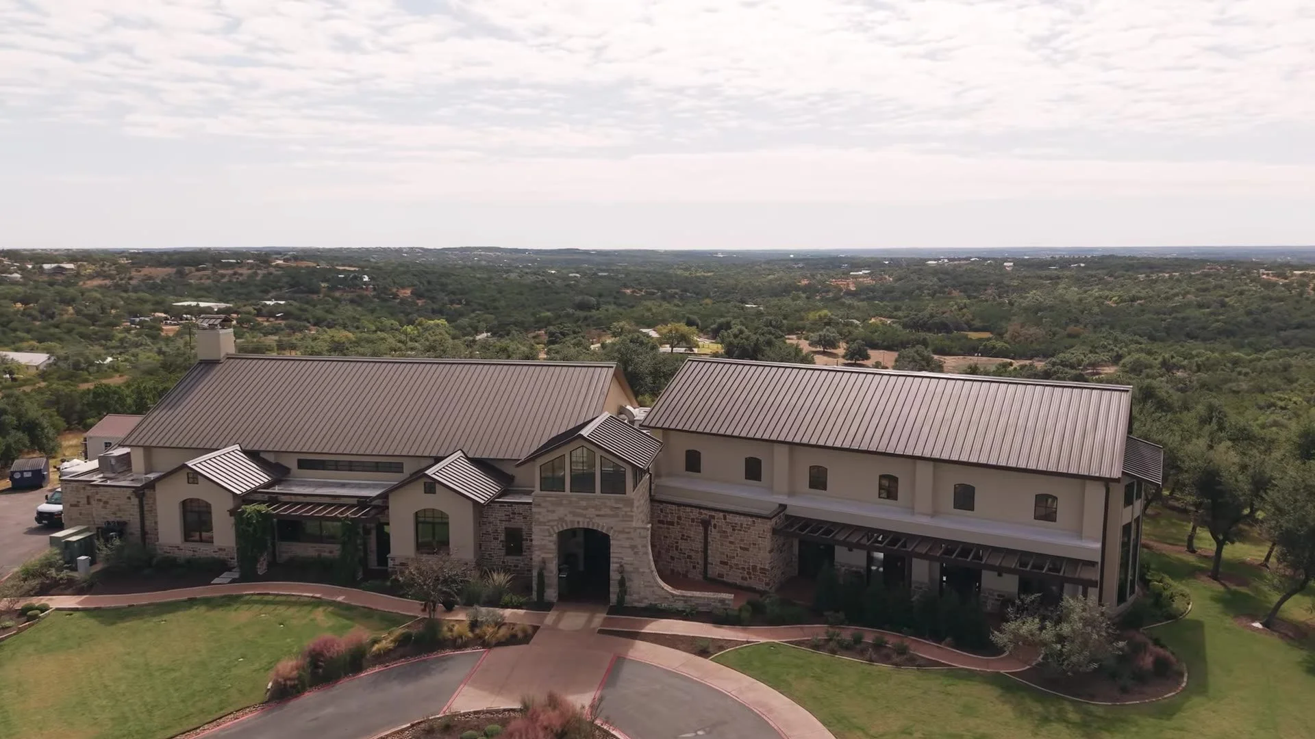Aerial view of the Canyonwood Ridge stone venue and lawns in the Austin Hill Country near Dripping Springs, Texas