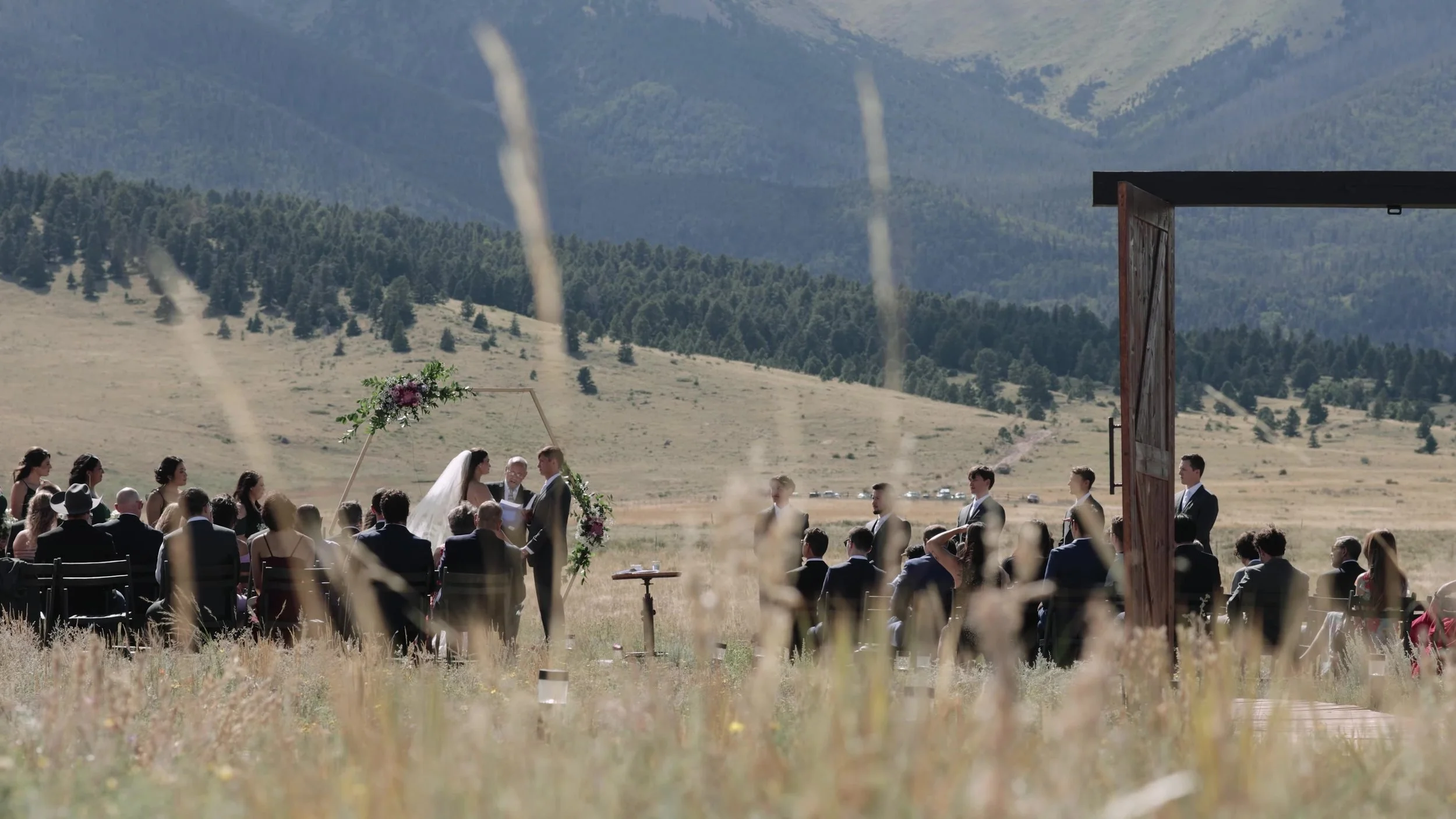 Super 8 wide ceremony through meadow grass at 3 Peaks Ranch in Westcliffe, Colorado