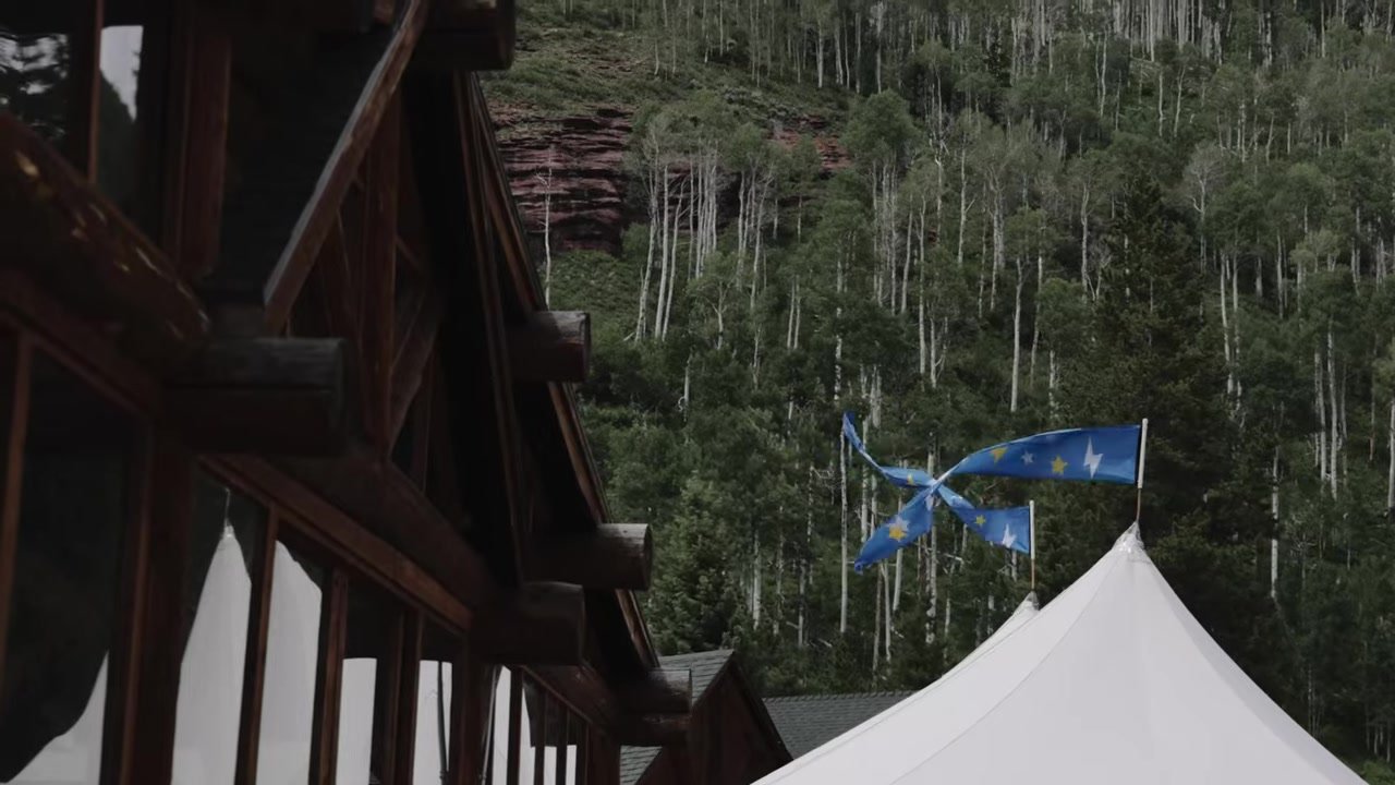 Log lodge, white sailcloth tent, and aspen hillside at Piney River Ranch after rain