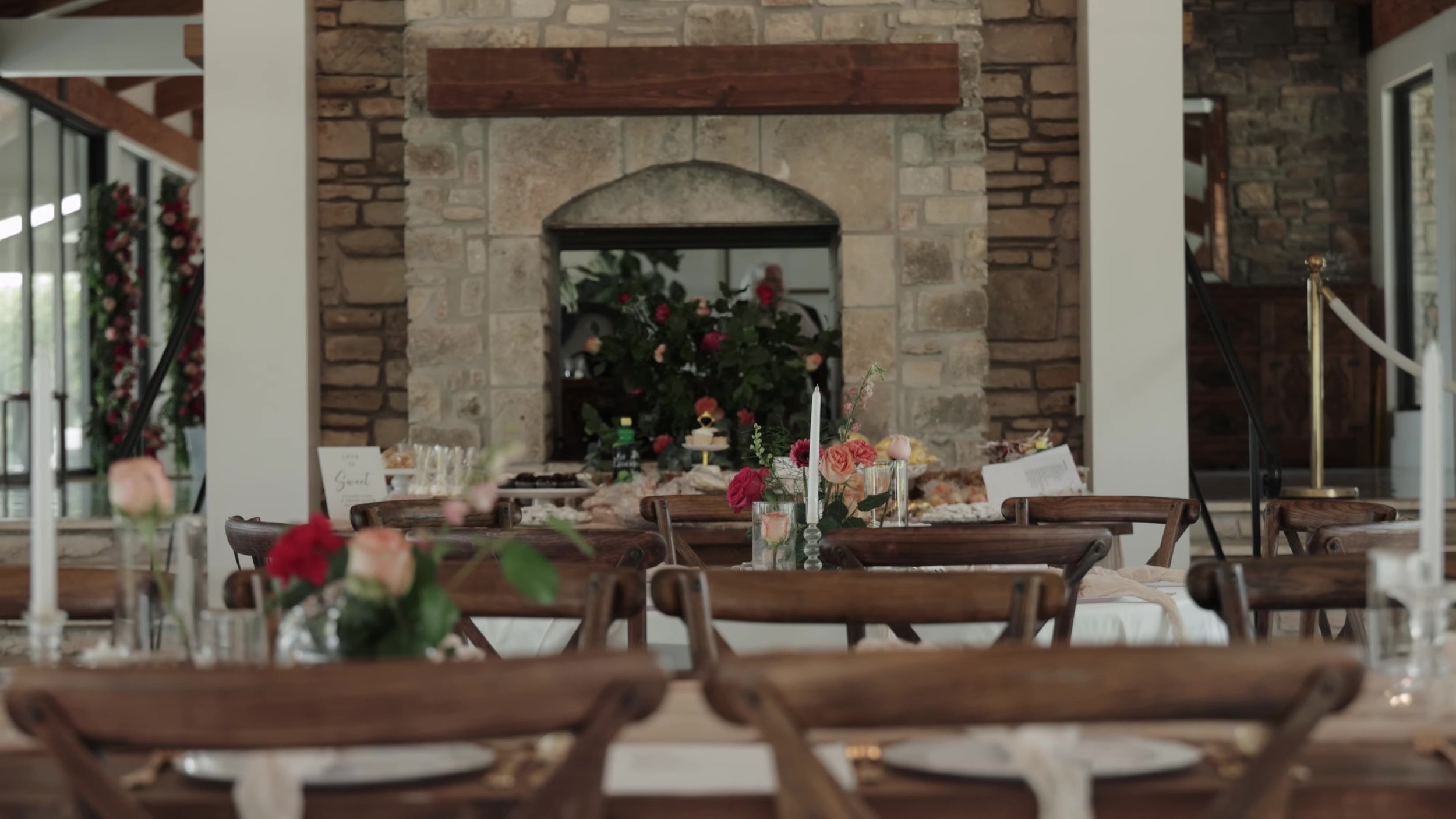 Stone fireplace and set reception tables inside Videre Estate near Austin Texas Hill Country