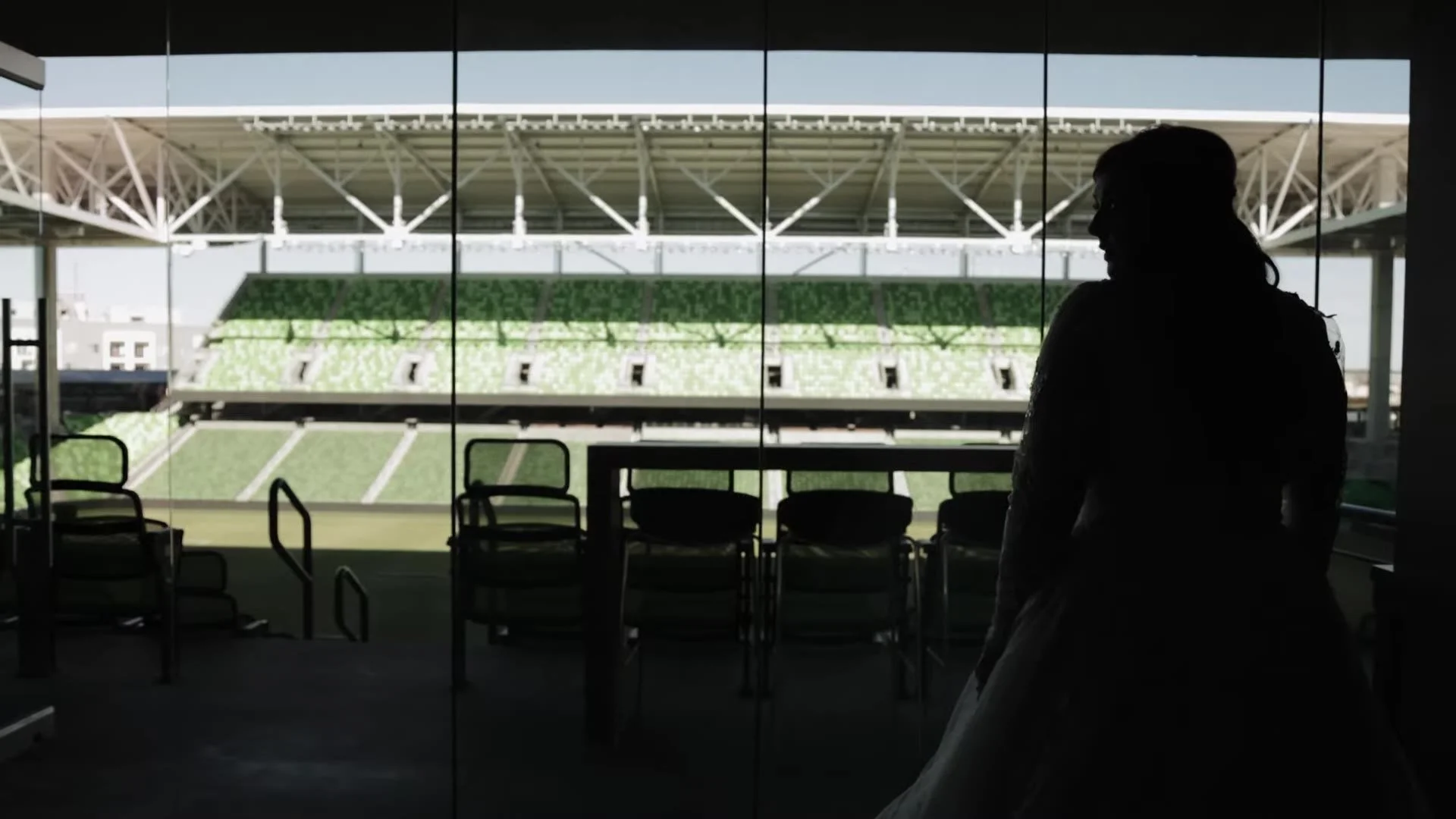Silhouette of Gabby looking out at the green seats of Q2 Stadium in Austin, Texas