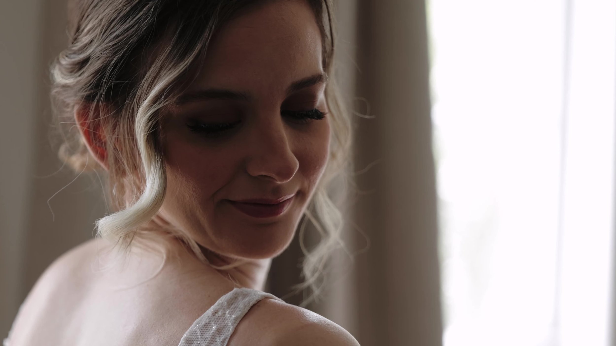 Soft portrait of the bride looking over her shoulder before the ceremony in Houston, Texas