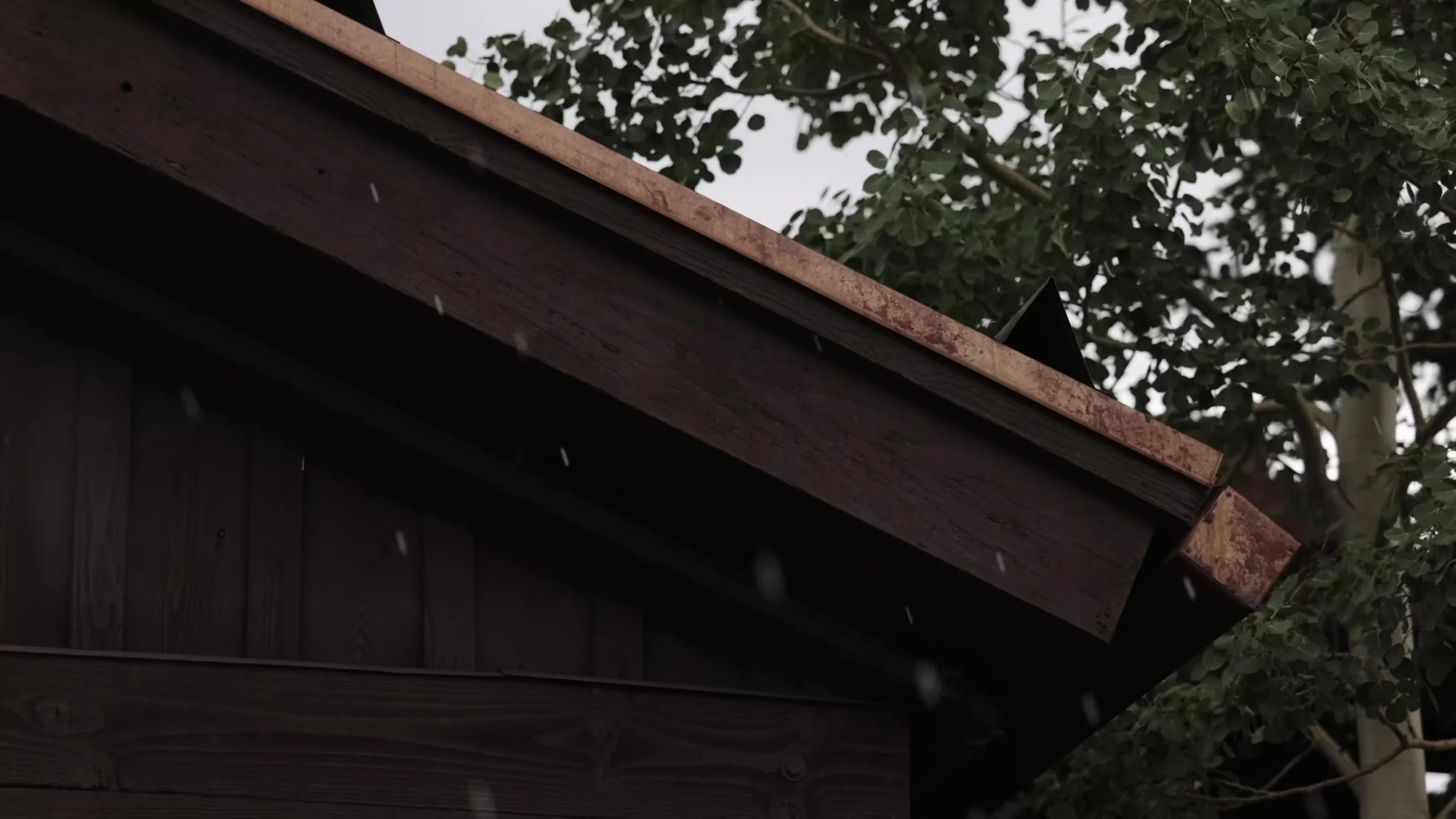 Hail falling on the wooden eaves of Ten Mile Station in Breckenridge, Colorado