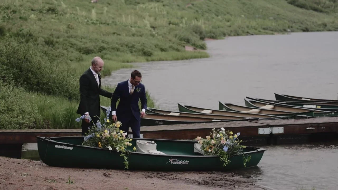 Patrick and Jake with a flower covered canoe at the Piney Lake dock