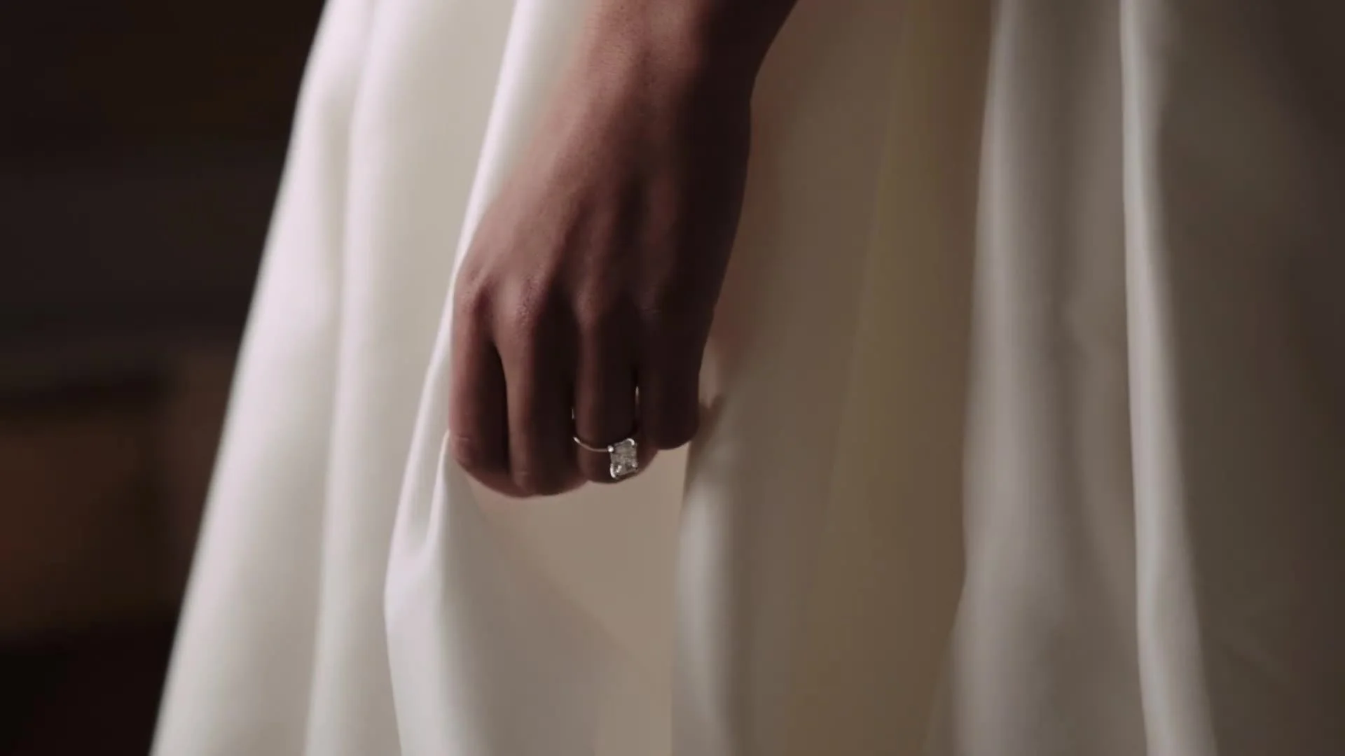 Emerald cut ring on the bride's hand against her gown at a Crested Butte Wedding Garden wedding in Colorado