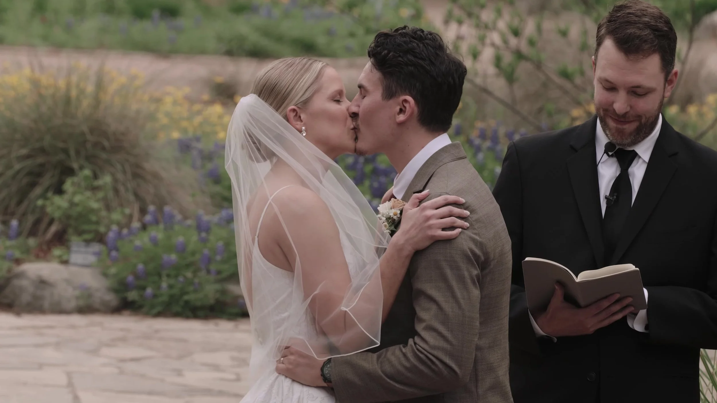 Heather and Chris first kiss at the outdoor ceremony altar at Lady Bird Johnson Wildflower Center in Austin, Texas