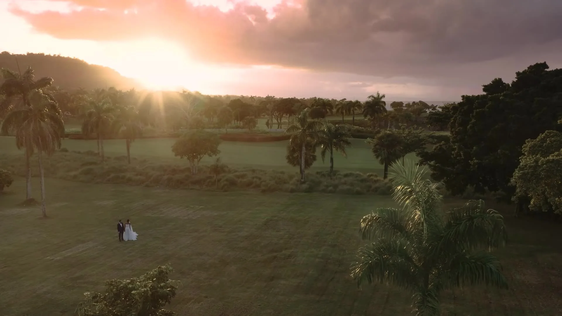 Aerial of Daniela and Adam in a golden field at Amanera Dominican Republic