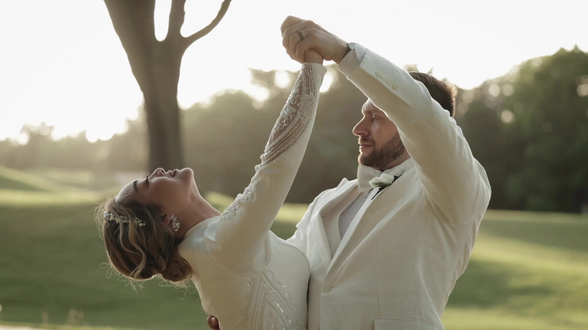 Keely and Jay dancing outdoors in golden hour light at Barton Creek Country Club Austin