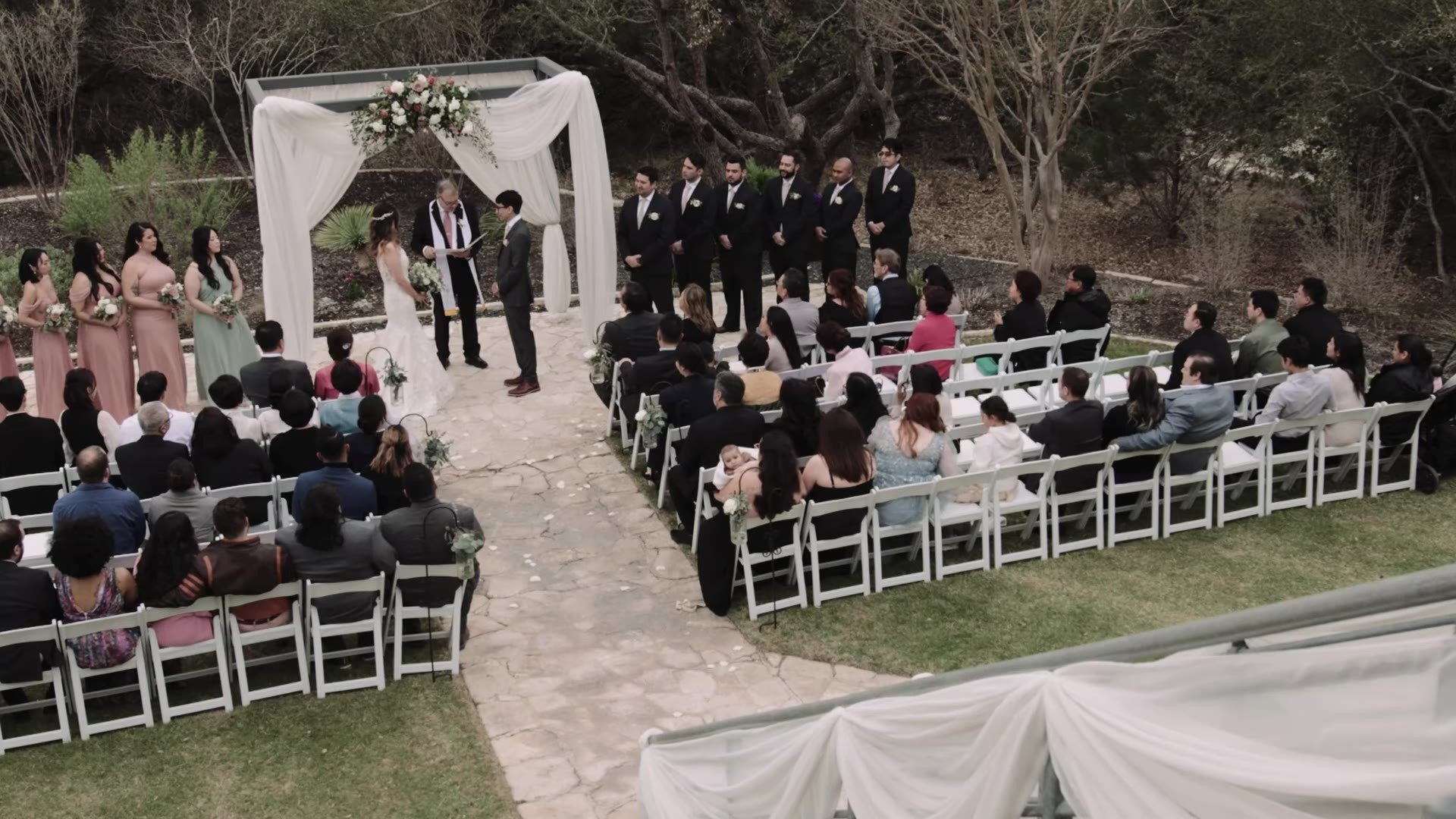 Wide elevated view of Manny and Jasmine's outdoor ceremony at The Terrace Club with guests in Korean hanbok