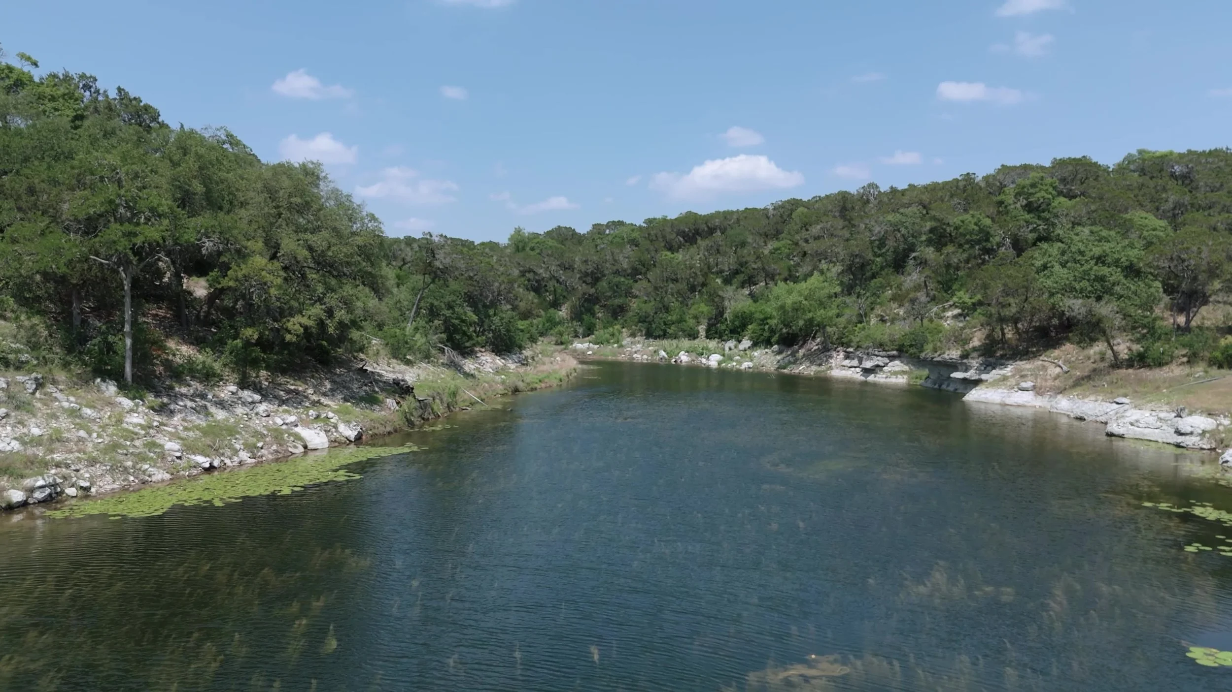 Limestone shore and calm water landscape at Videre Estate in Texas Hill Country near Austin