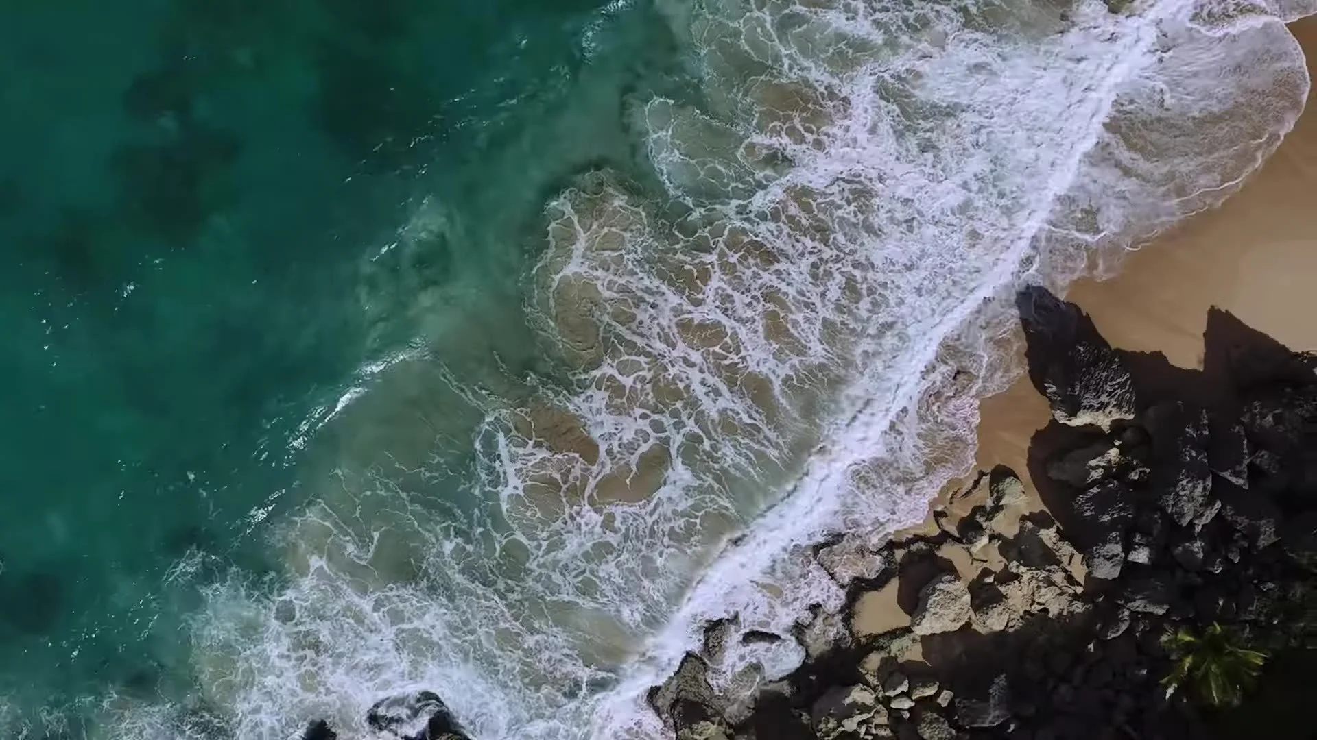 Aerial of white surf on rocky Dominican Republic shoreline near Amanera