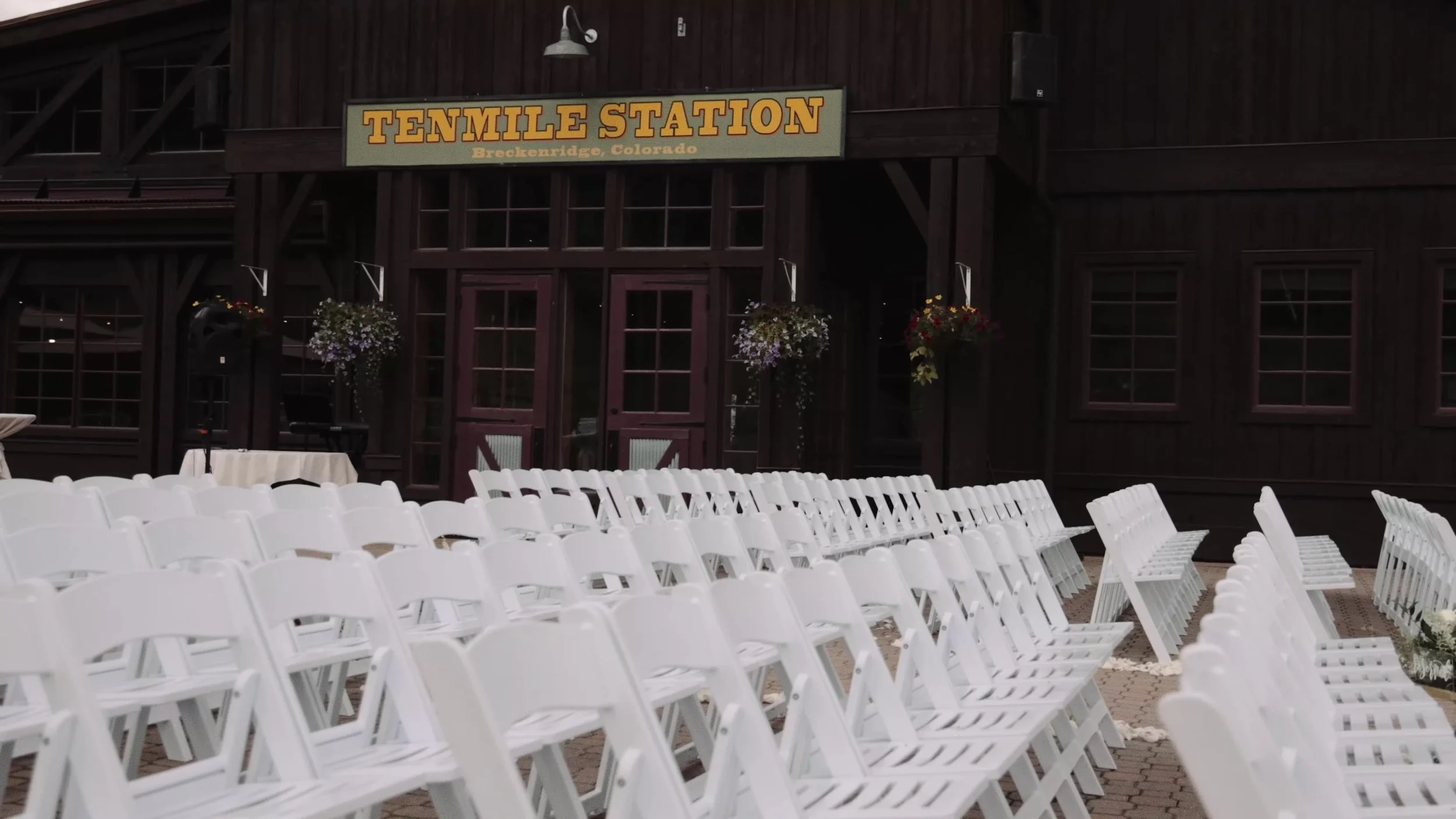 Empty outdoor ceremony chairs facing the Ten Mile Station lodge in Breckenridge, Colorado