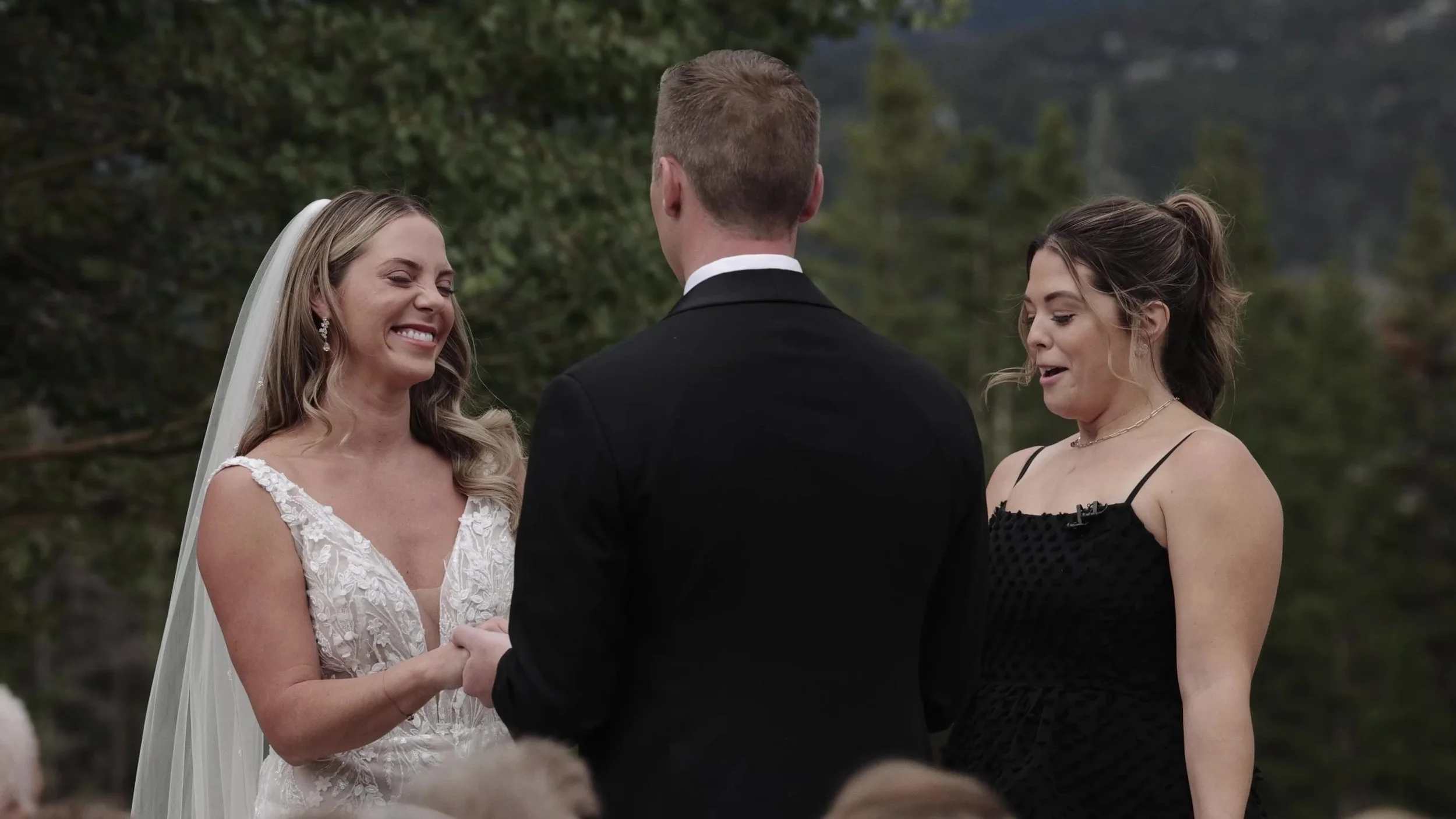 Caitlin laughing during vows with Matthew at their Breckenridge Colorado ceremony