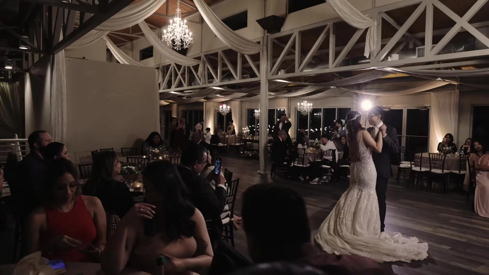 Manny and Jasmine first dance under draped ceiling and chandeliers at The Terrace Club Austin