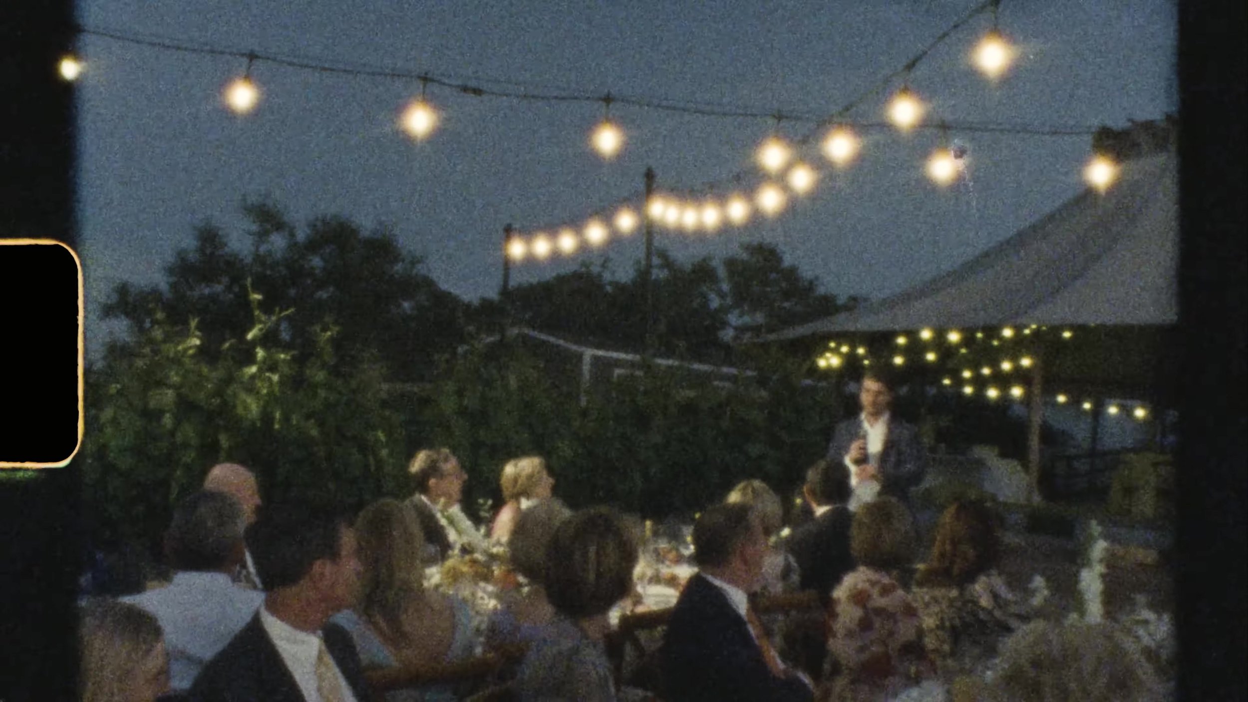 Night reception long tables under string lights at Camp Lucy Vineyards in Austin, Texas, best table setup