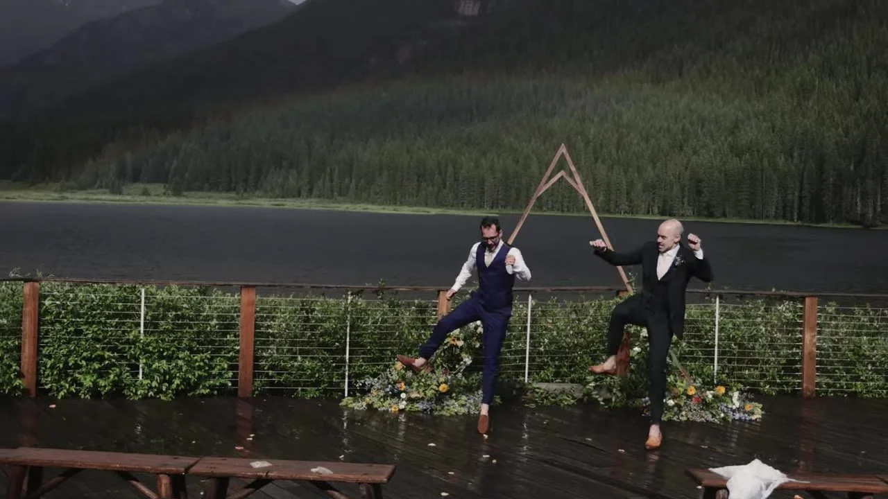 Patrick and Jake kicking on the wet ceremony deck at Piney River Ranch with Piney Lake behind them