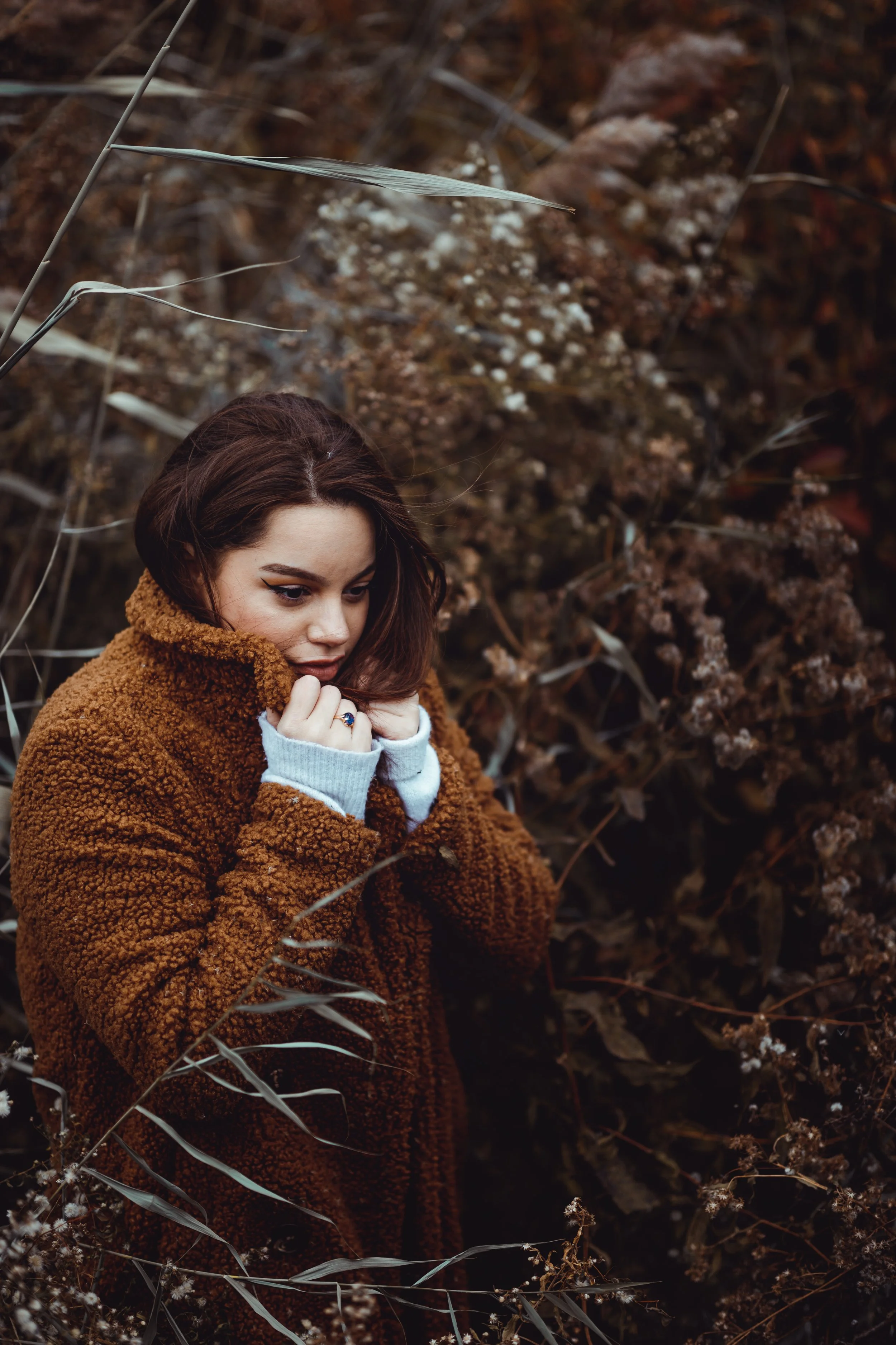 Portrait framed by dry grasses and autumn plants in Central Park.
