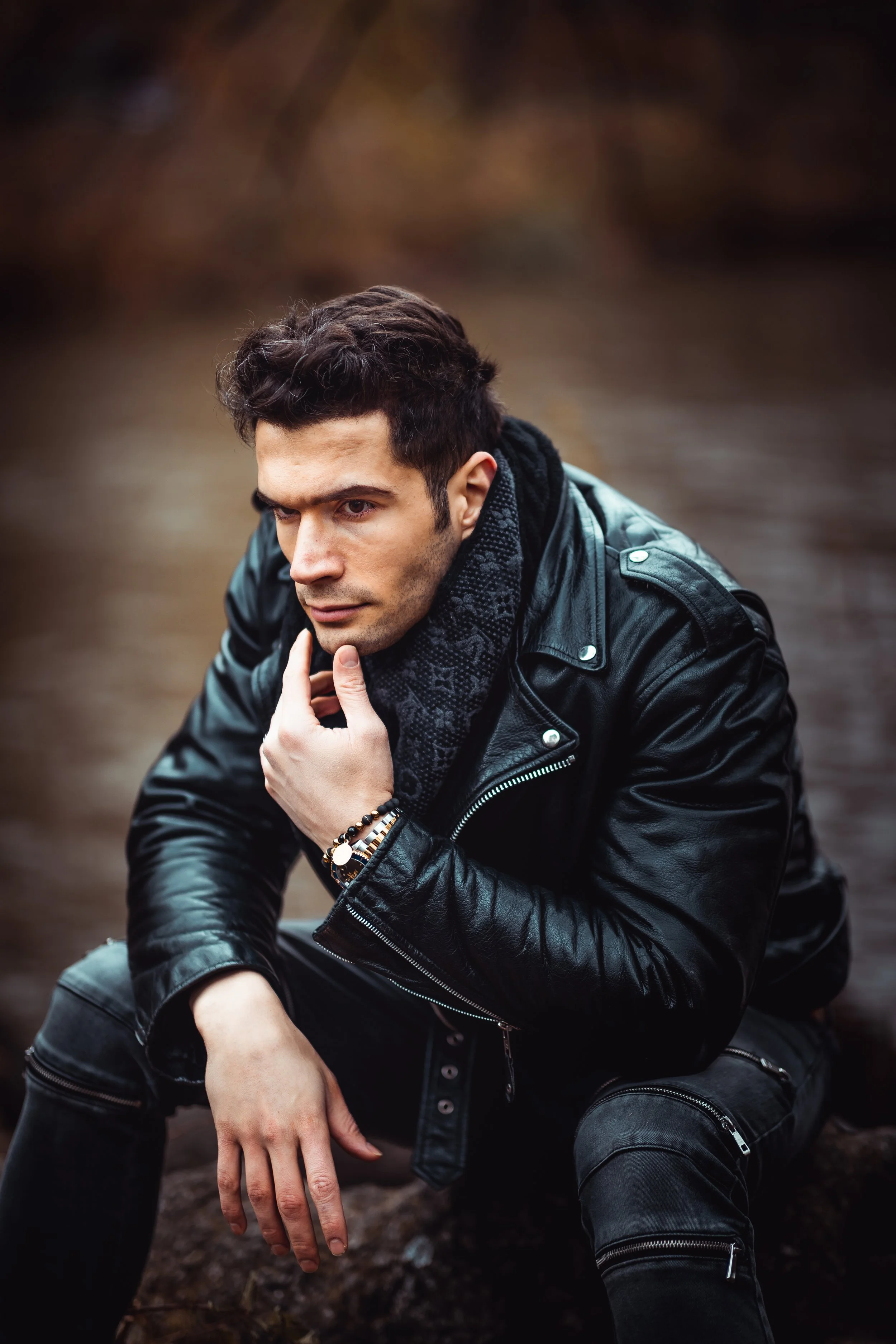 Cinematic close-up portrait with leather jacket near the water.