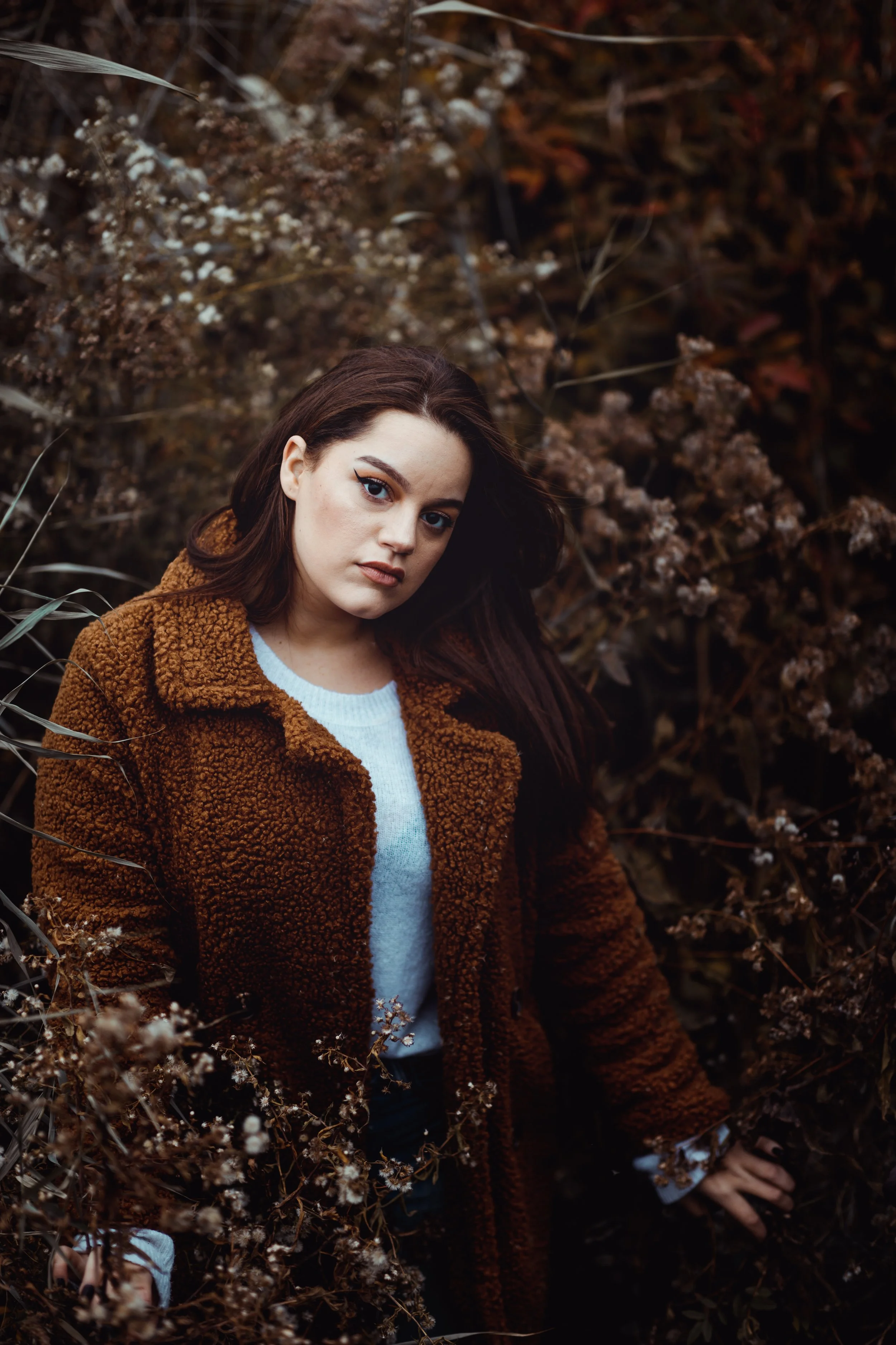 Portrait standing among dried autumn plants in Central Park.