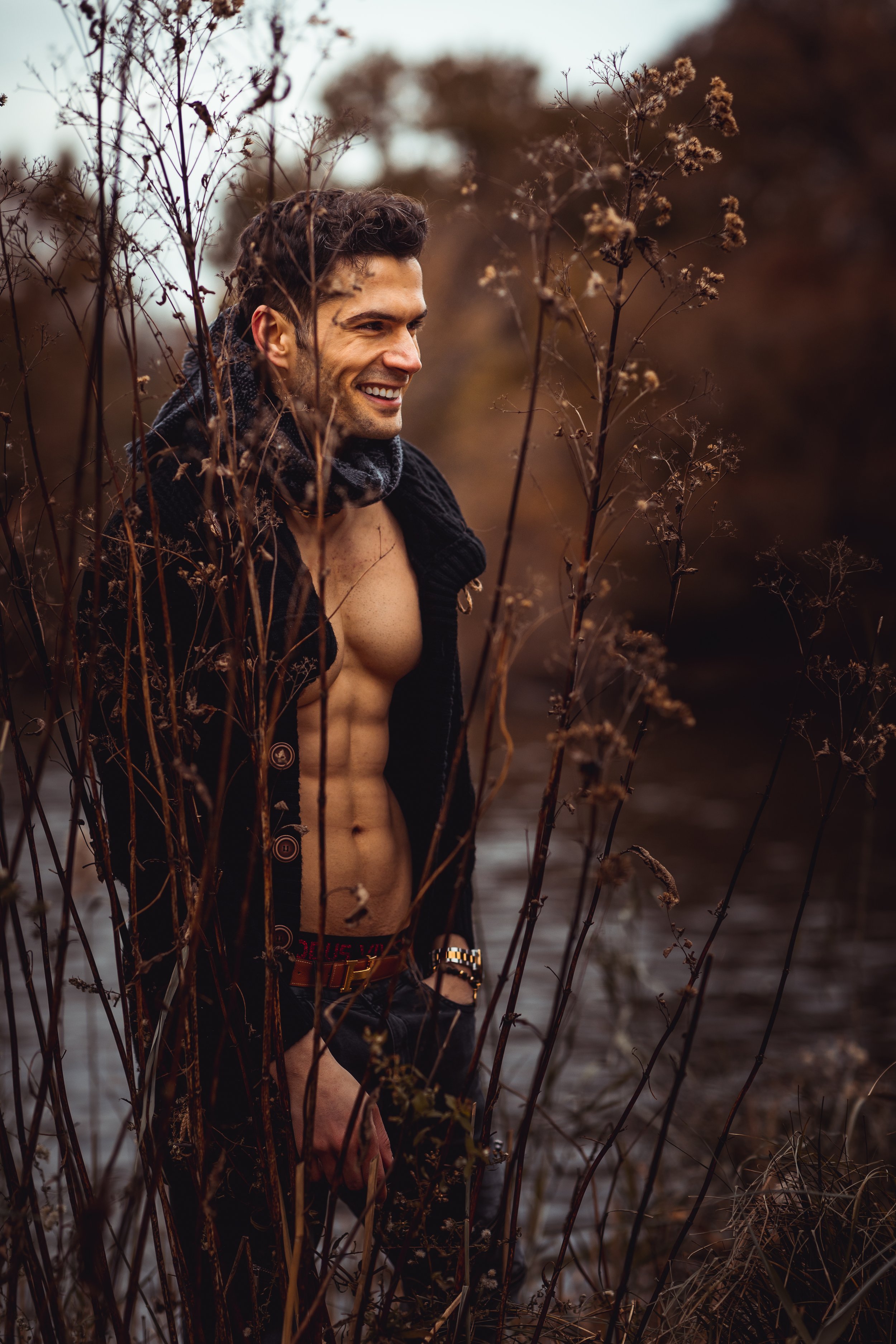 Smiling portrait among tall grass by the water in Central Park.