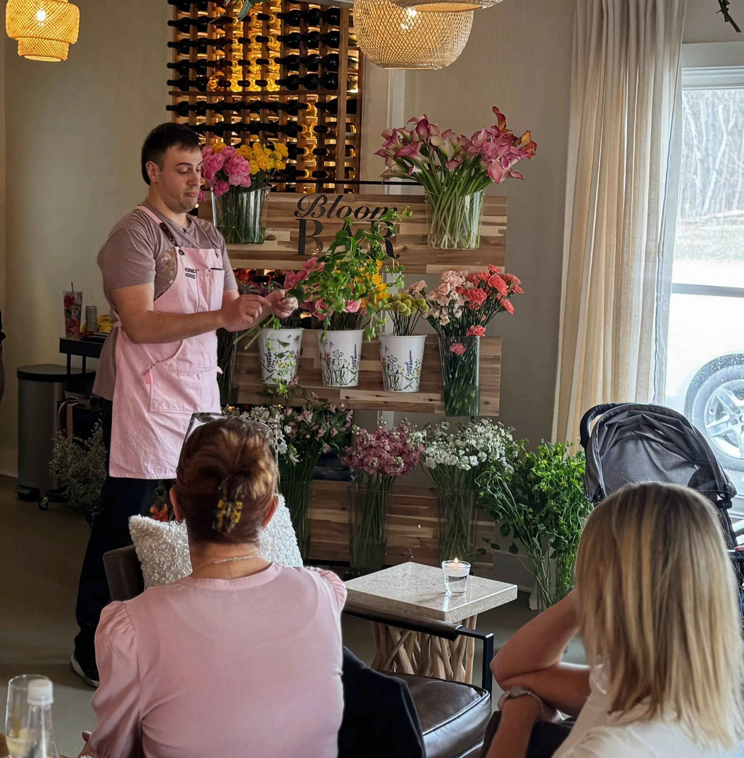 Ed demonstrating flower arranging to a seated workshop group.