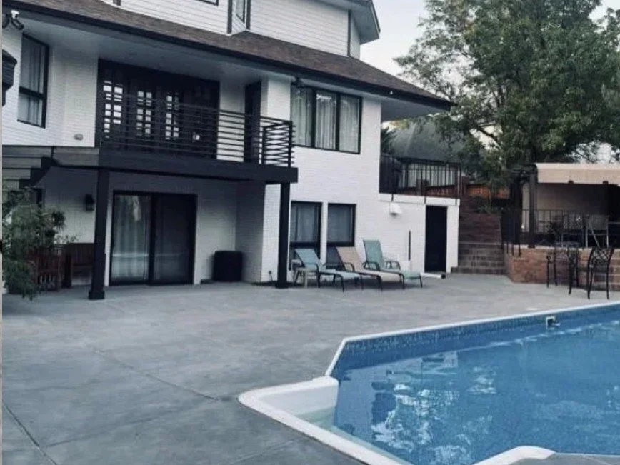Vintage concrete patio finish around a backyard pool by Colorful Concrete LLC in Greeley, Colorado
