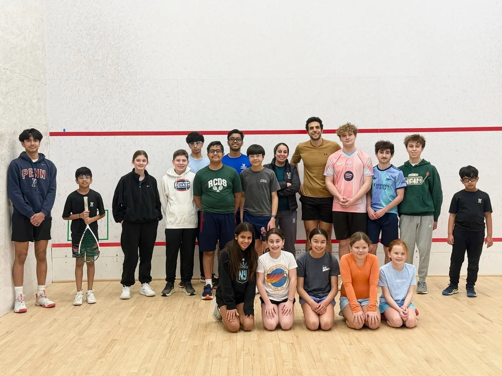 Omar Mosaad with junior players and a coach at Monmouth Squash & Swim