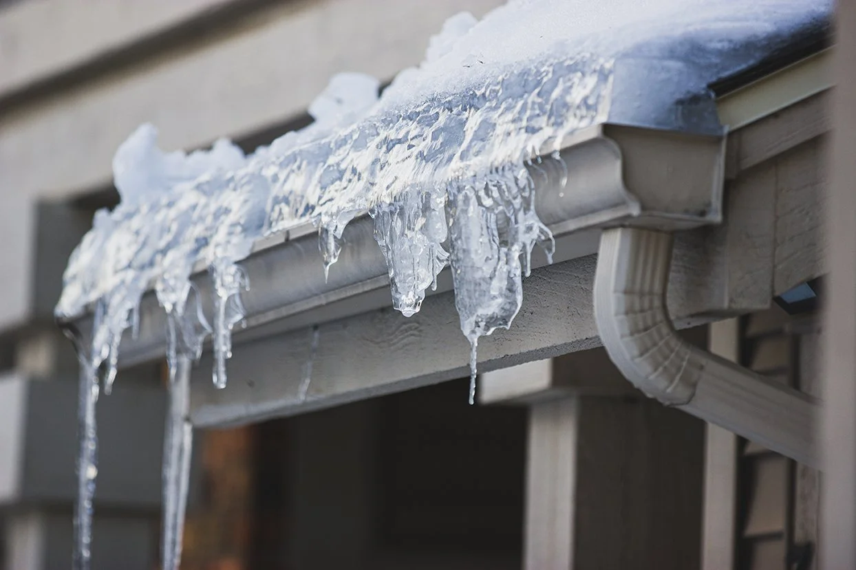 Frozen gutter with ice dam on Detroit home