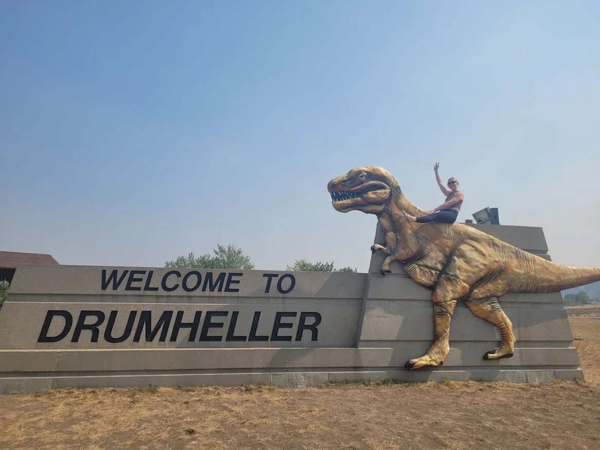 Roberta Farion, Communications Associate at reVerb, at the giant Tyrannosaurus rex in Drumheller