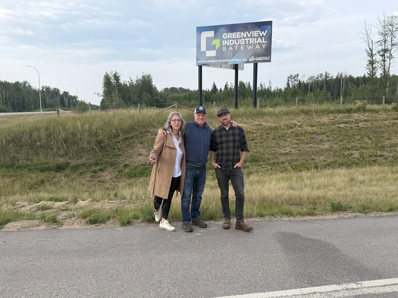 Rachel Rae, Graeme McElheran and Tim Wilson of reVerb in front of the Greenview Industrial Gateway sign