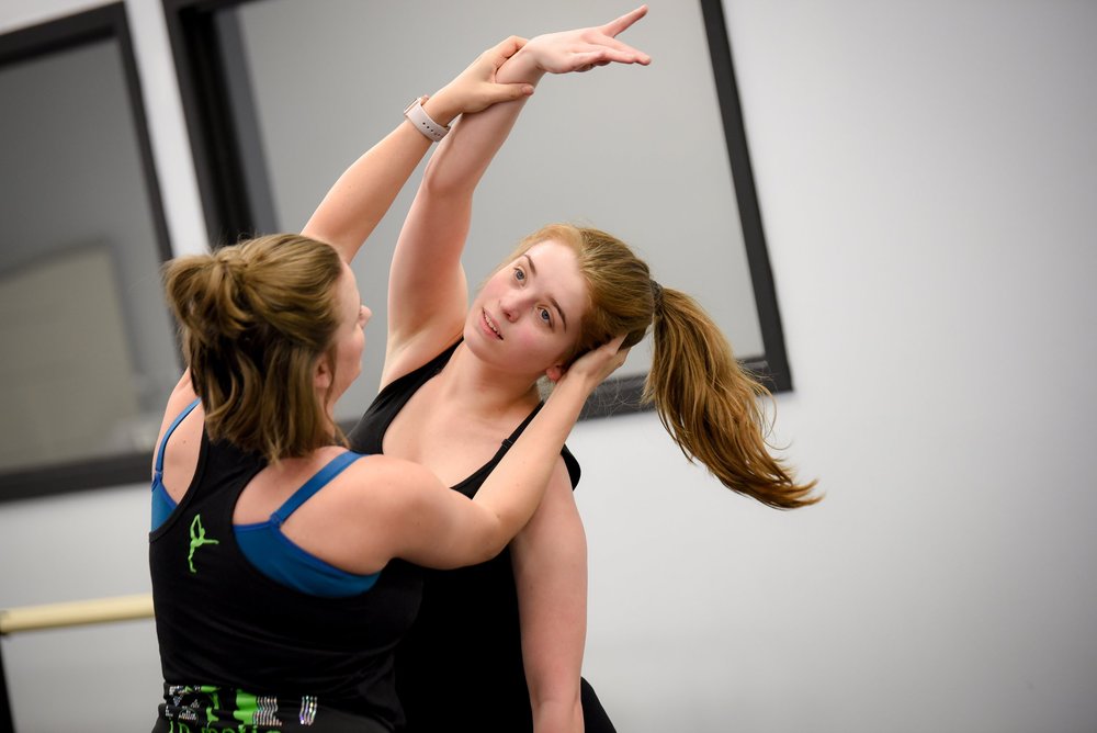 A dancer practicing technique in the studio
