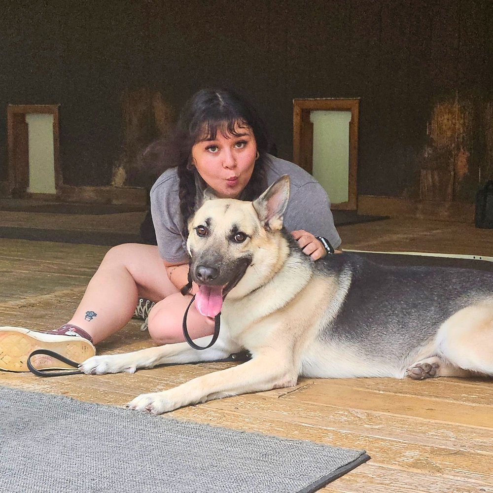An owner sitting with her German Shepherd