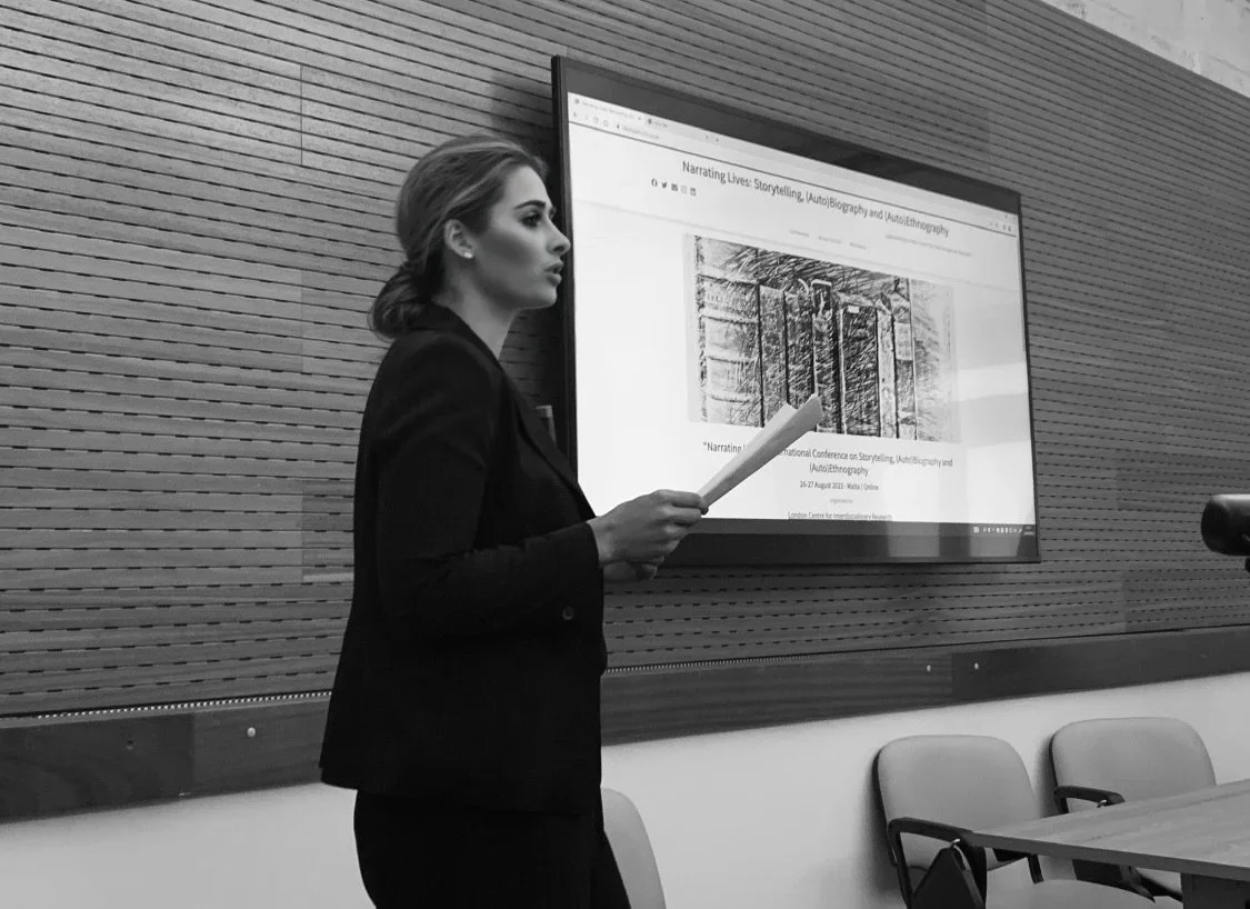 Dr. Jacqueline presenting research with slide background