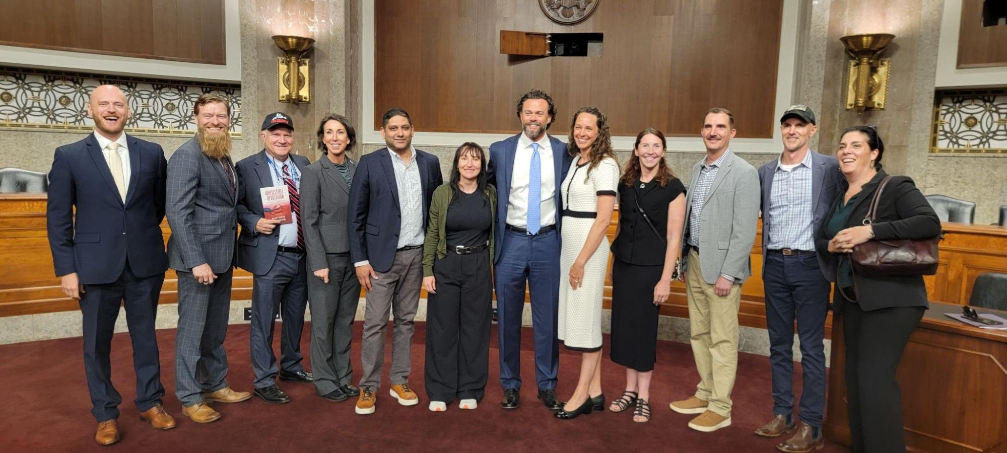 SWW President Michael Cassidy and General Counsel Davis Younts (left end) stand with Lt. Col. Matt Lohmeier (center) and friends at his Senate confirmation Hearing.