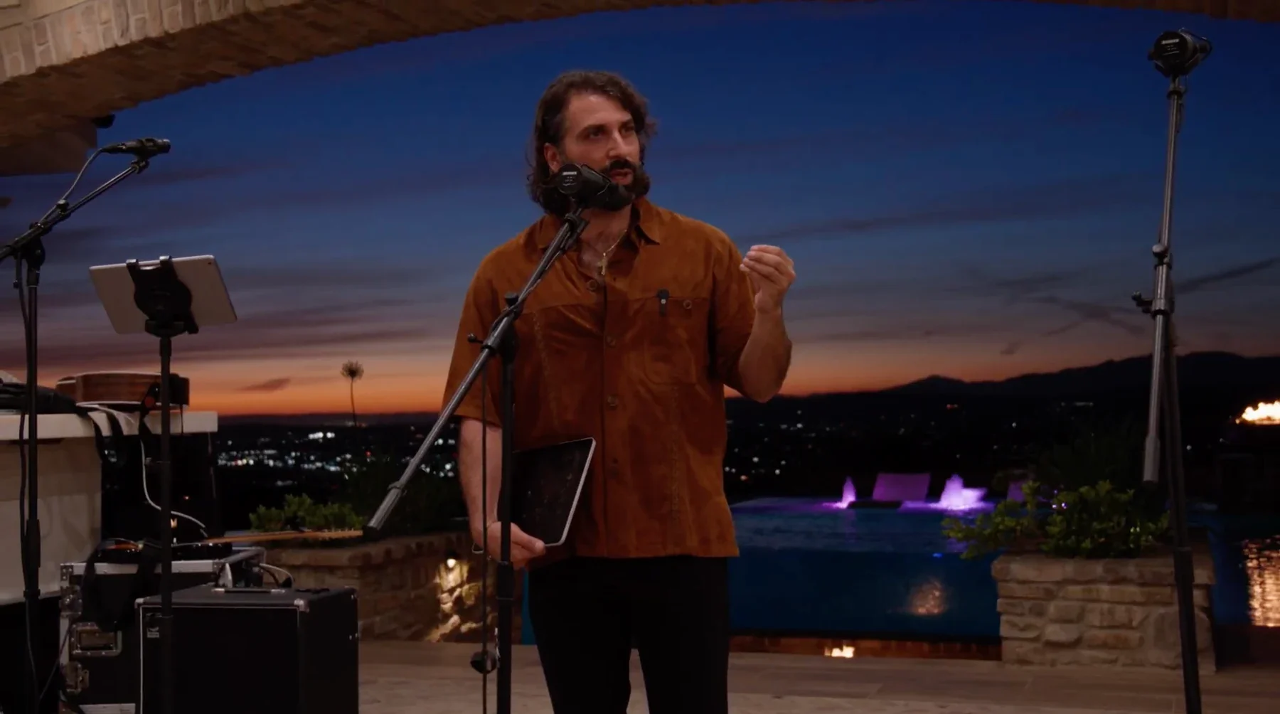 Daniel teaching at an outdoor gathering at sunset