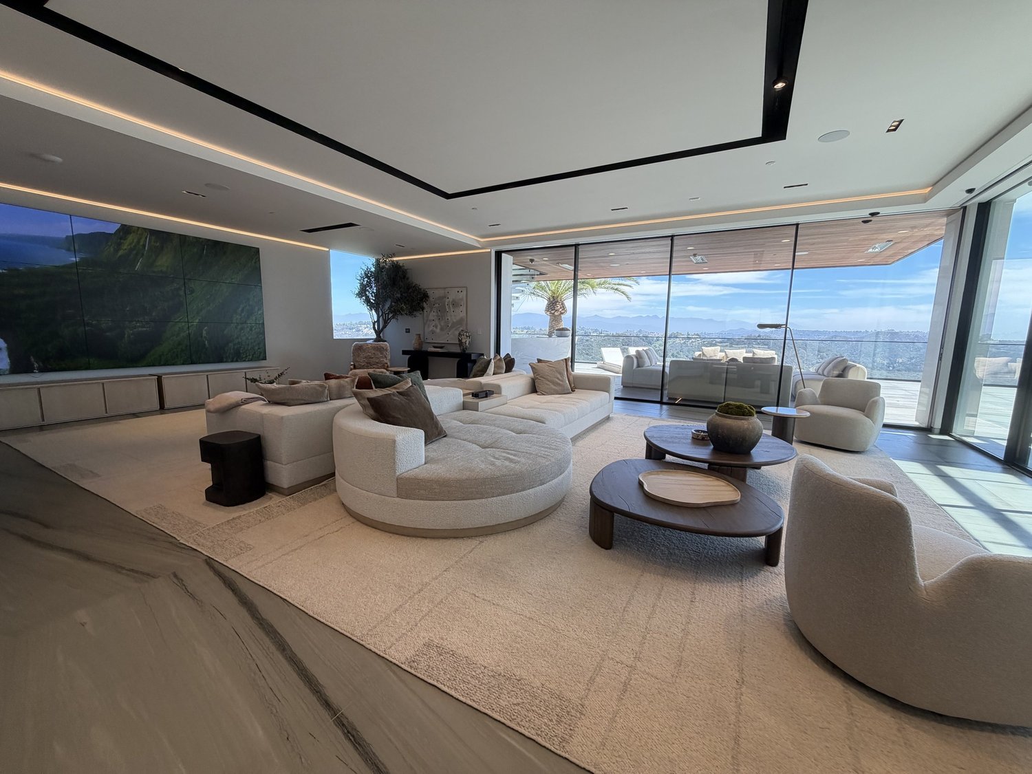 Modern Hollywood Hills living room with sculptural seating and panoramic city views.